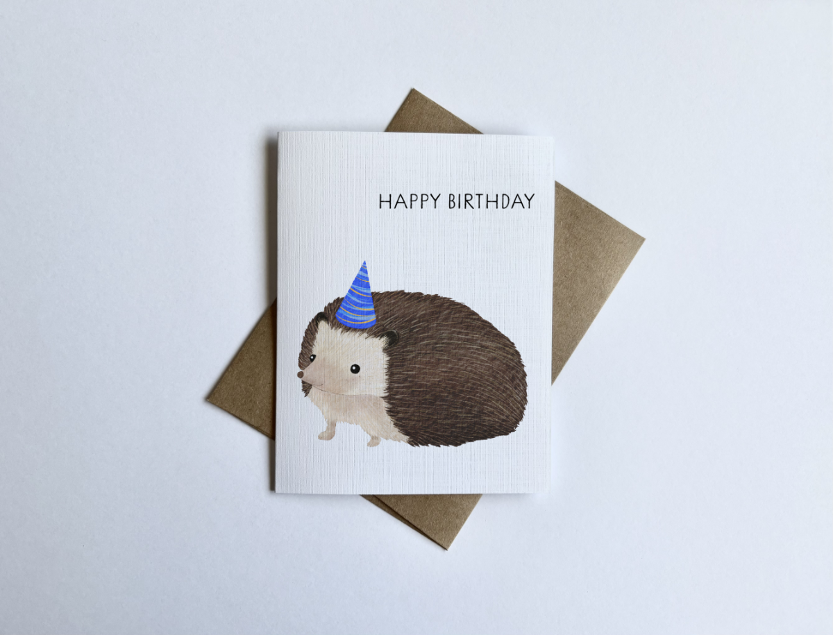 Cute hedgehog birthday card with party hat illustration, whimsical animal birthday greeting card