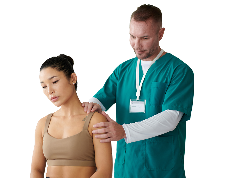 A healthcare professional in teal scrubs examines a woman in a beige tank top, touching her shoulder gently in a clinical setting.
