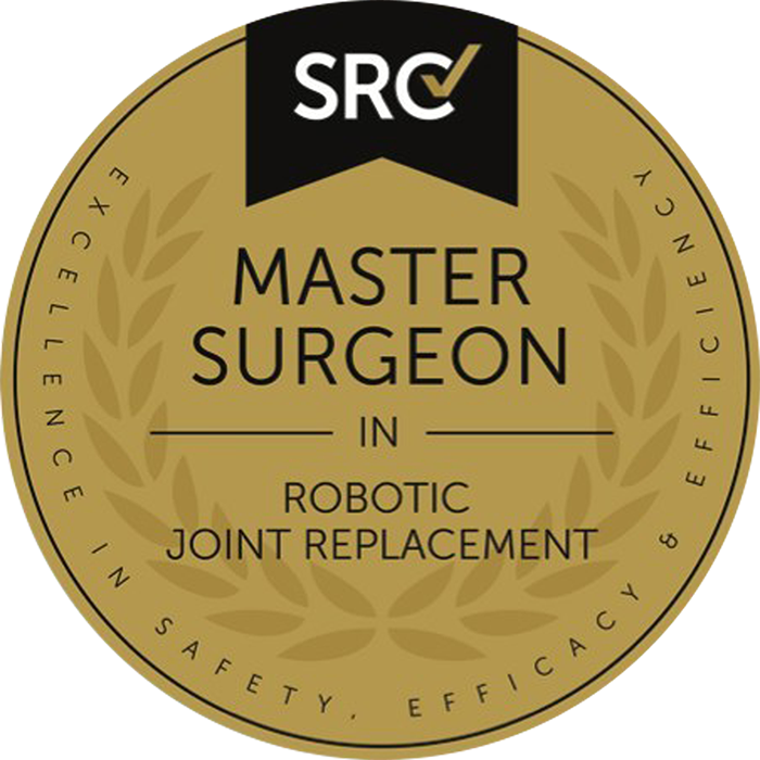 Gold and black badge with the SRC logo at the top, text indicating certification for master surgeon in robotic joint replacement, surrounded by a laurel wreath, emphasizing excellence, safety, and efficacy.