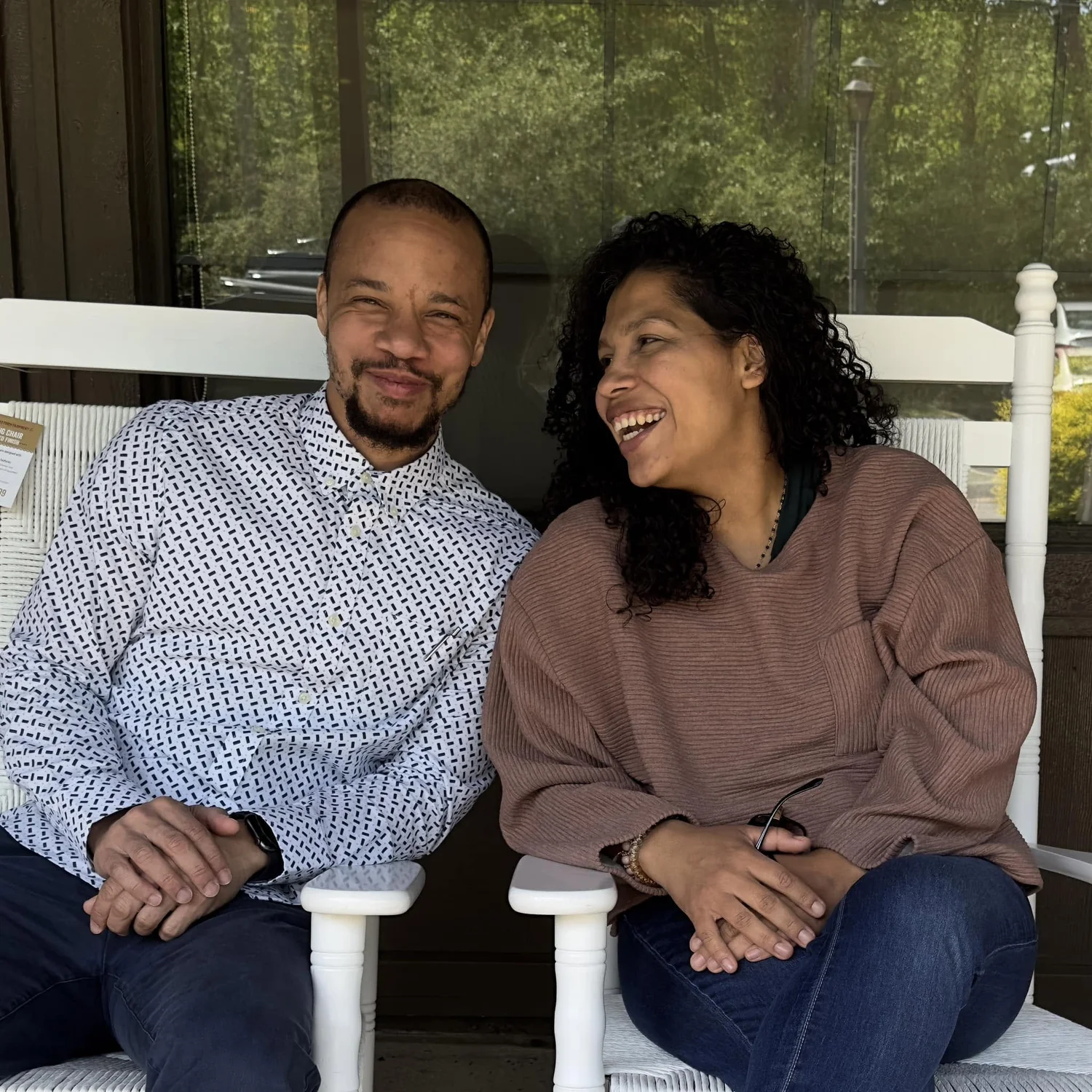 Lead Pastor Ryan and his wife Lissette smiling together on a porch