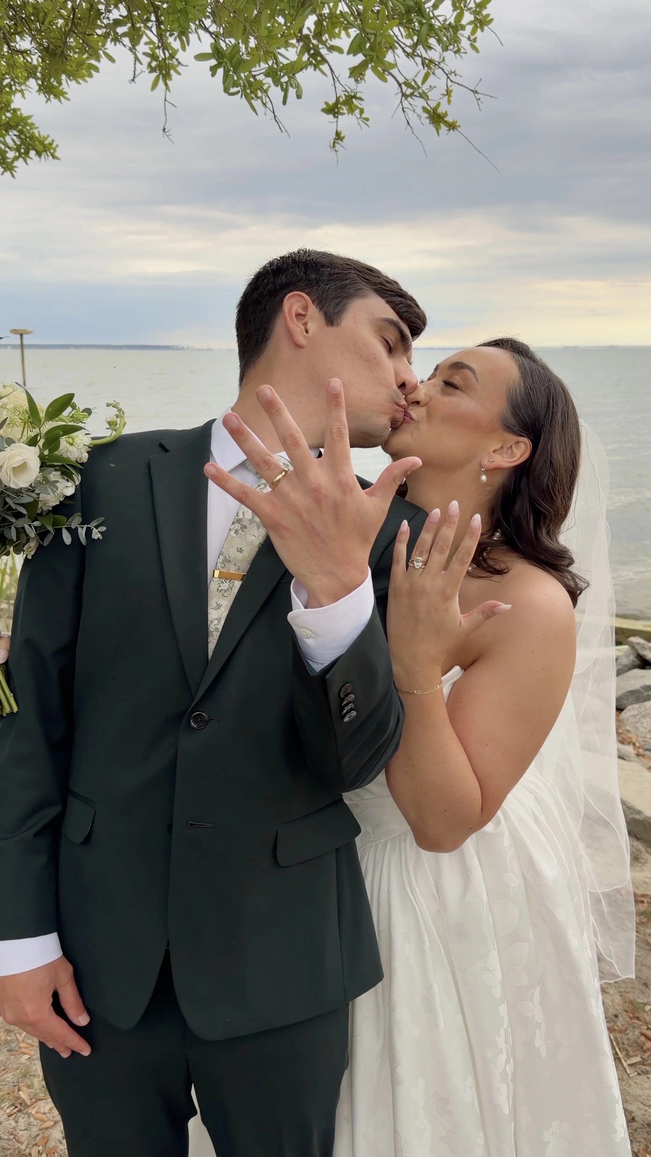 A newlywed couple kissing outdoors in the outerbanks by wilmington content co - content creator in north carolina