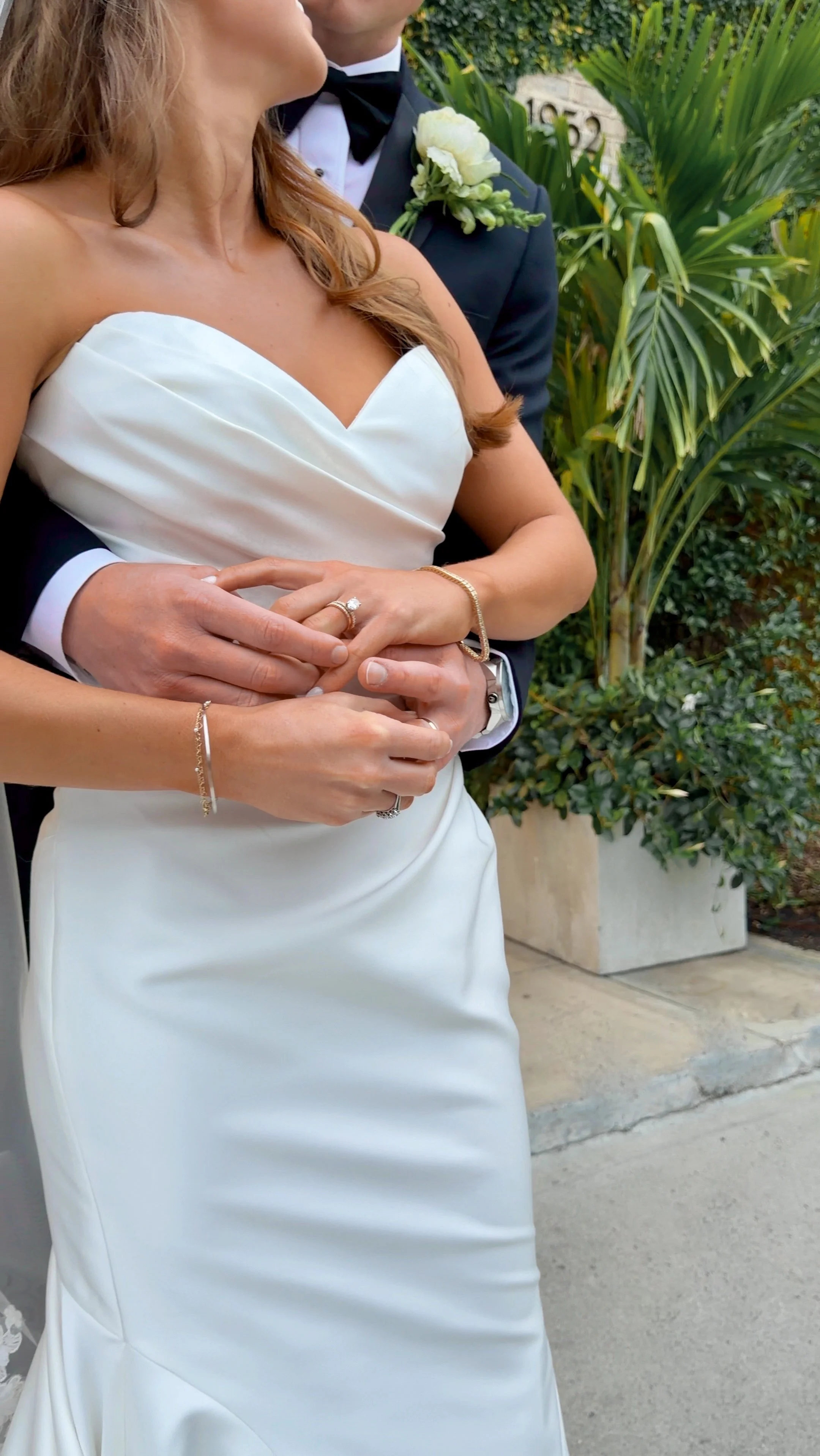 Close-up of a bride and groom holding hands during a wedding ceremony at wrightsville manor by wilmington content co - content creator in north carolina