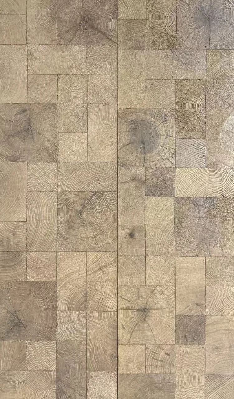 Close-up view of a wooden surface made of square and rectangular wooden blocks with visible grain patterns and growth rings.