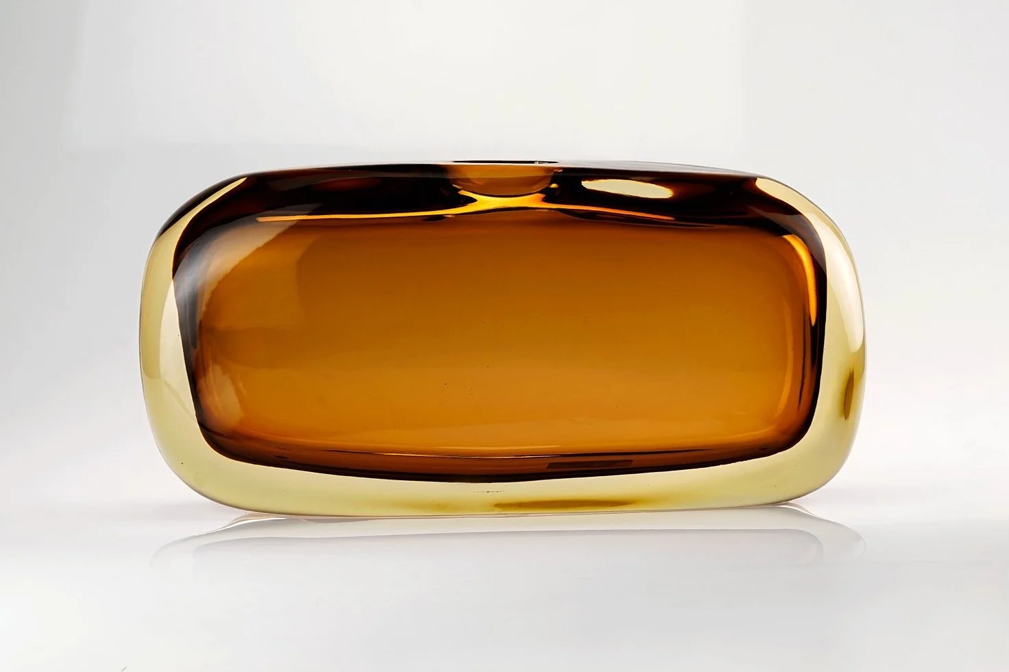 A rectangular brown glass container with rounded edges, seen from the front against a white background.