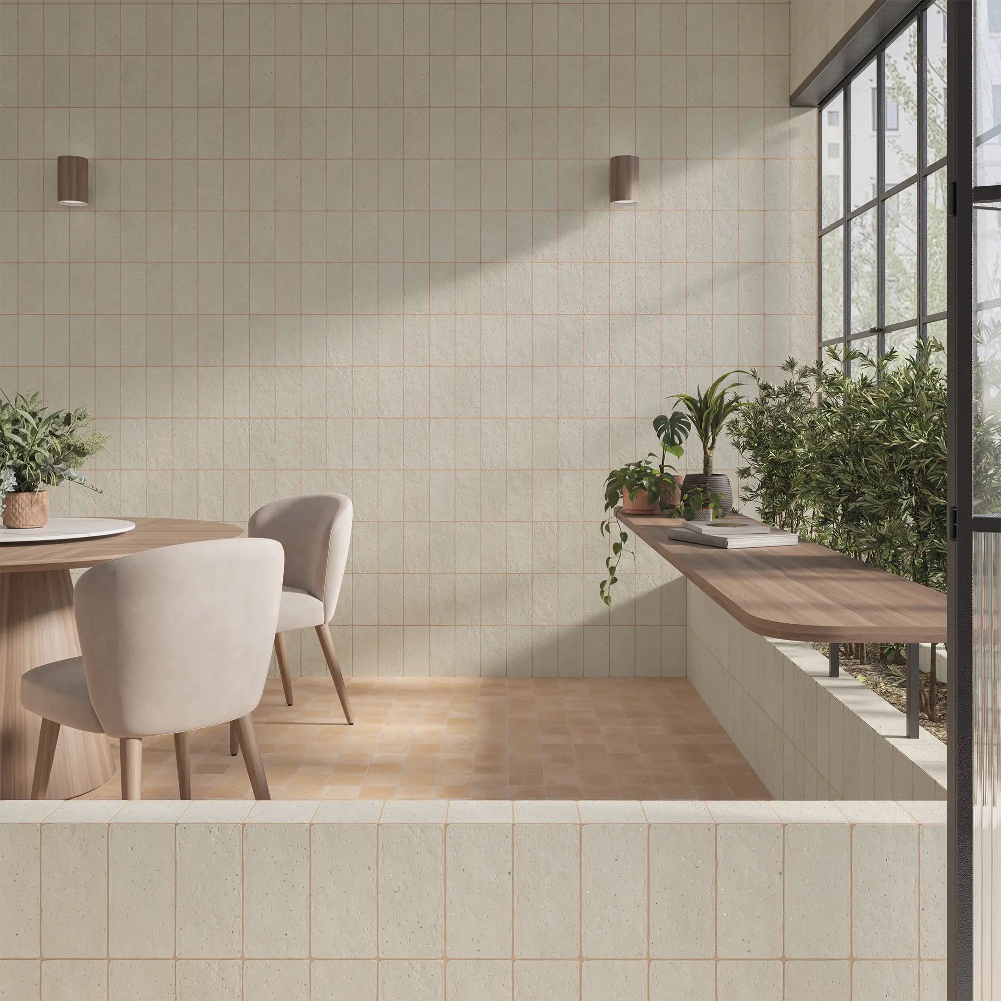 Modern dining area with beige chairs, potted plants, a wooden table, and a window showing green trees outside.