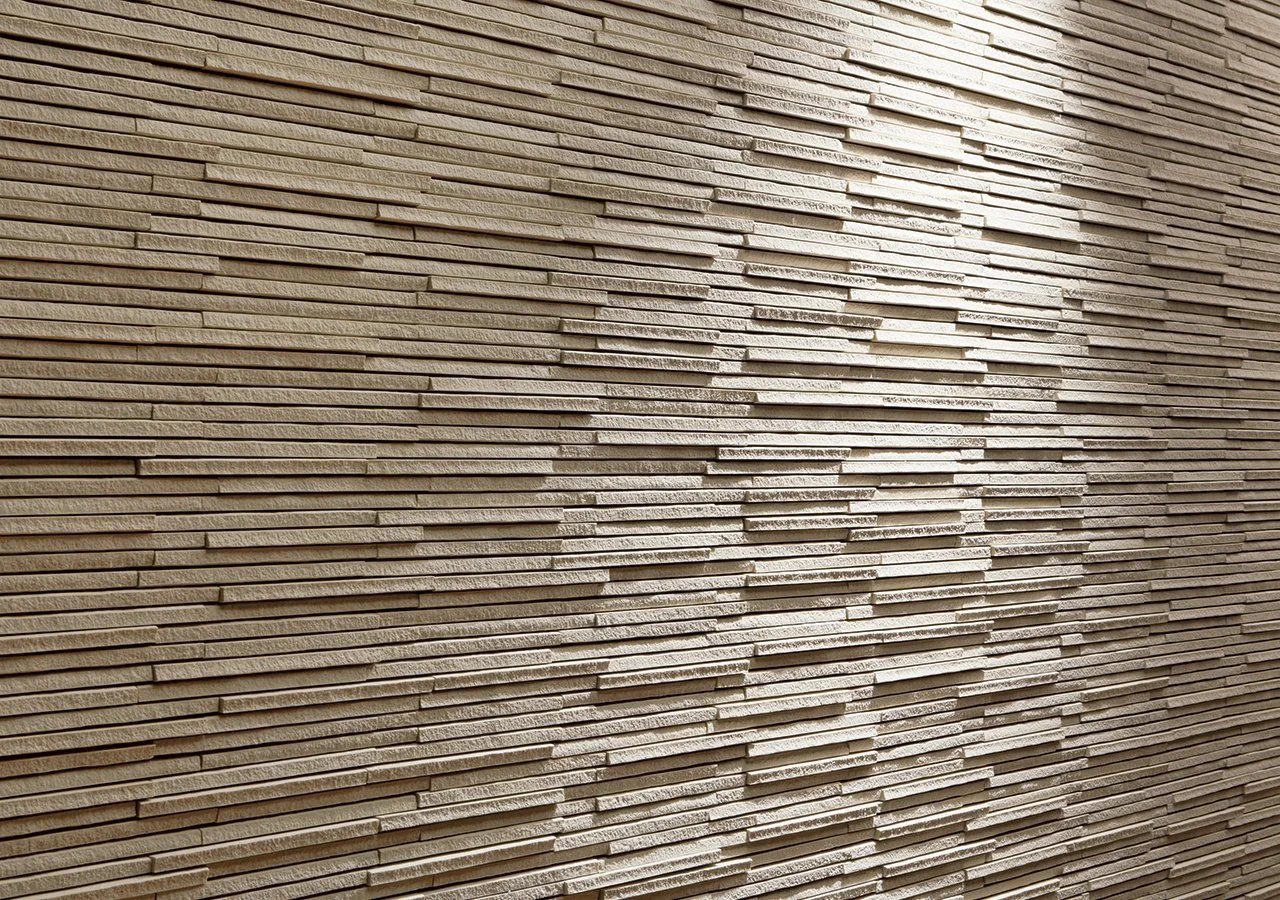 Close-up of a textured beige brick wall with an irregular pattern.
