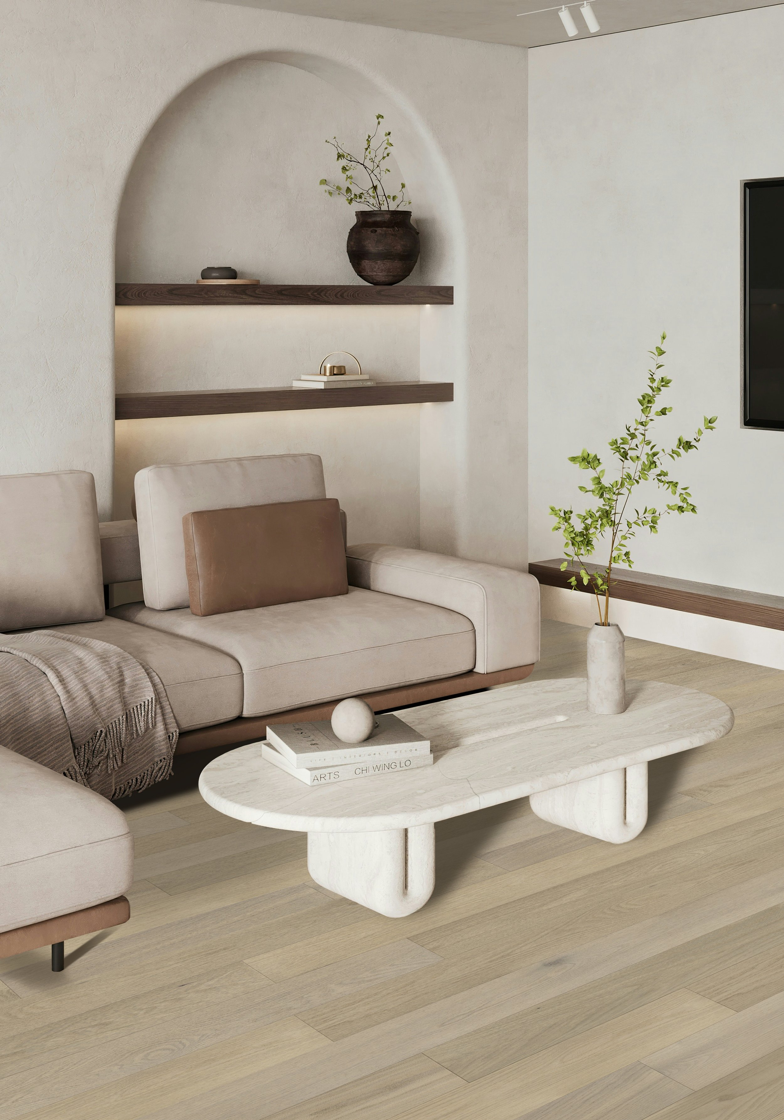 Modern living room with beige sofa, low marble coffee table, decorative vase with green leafy branch, wall-mounted wooden shelves, and a flat-screen TV.