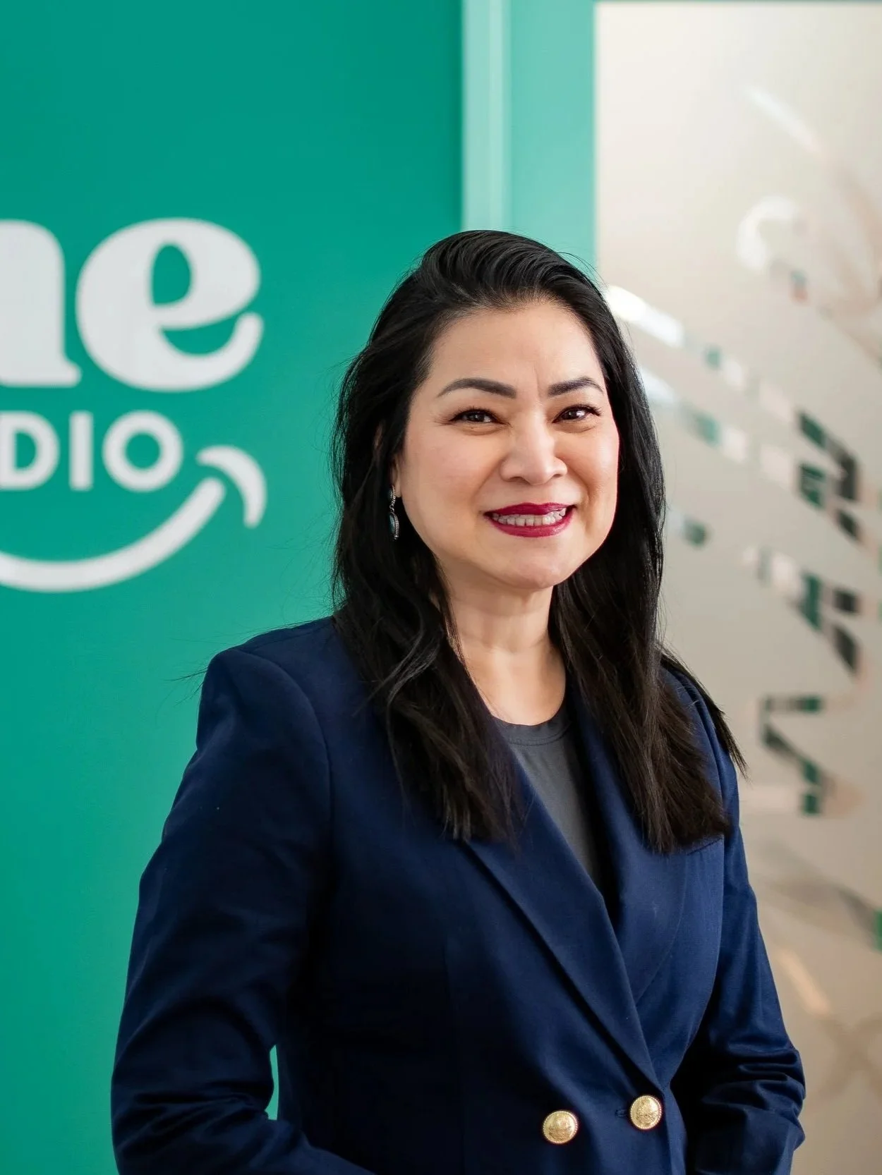 Dr. Alissa Tran, orthodontist at Shine Ortho Studio, smiling in the office