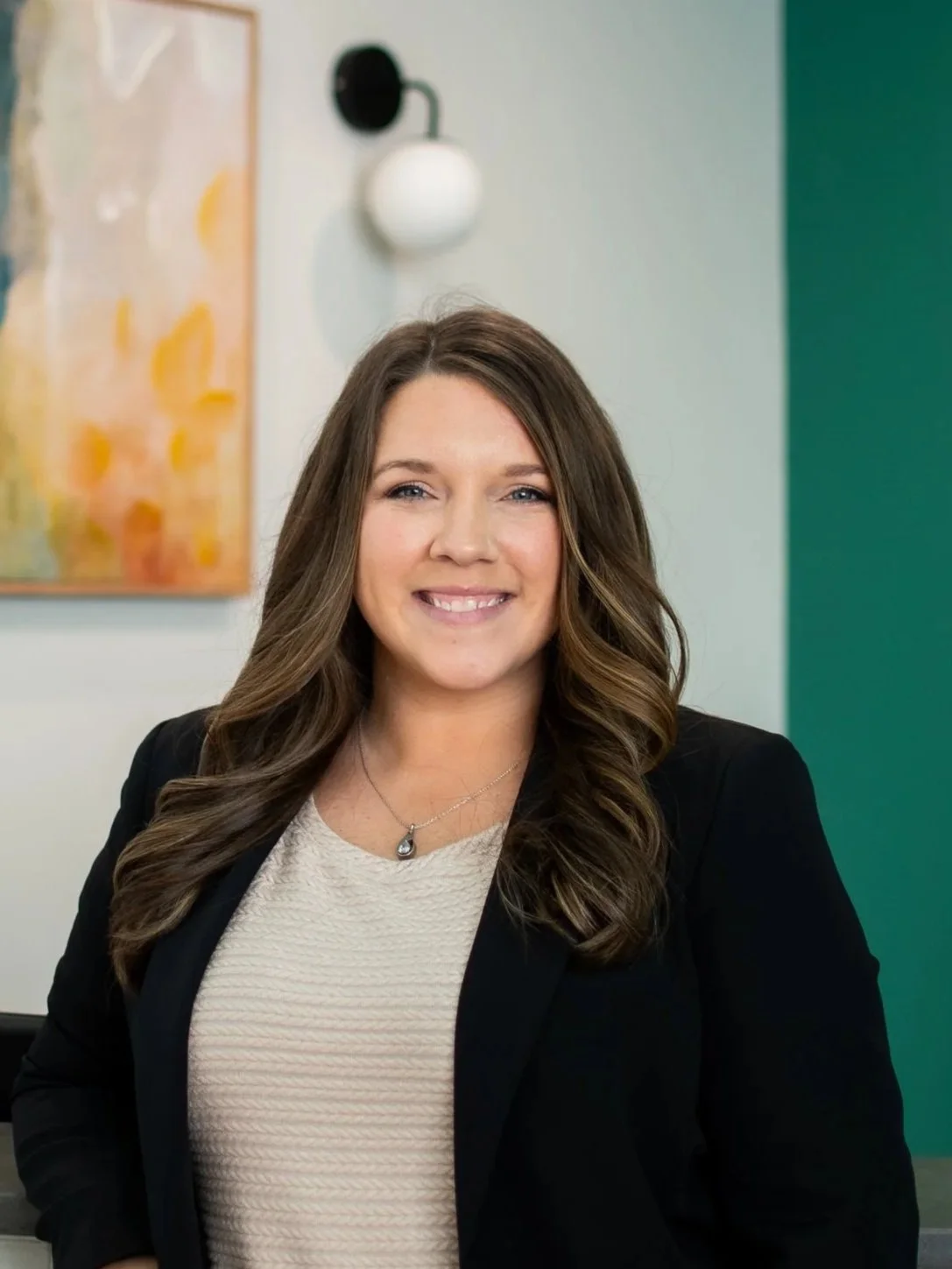 Krista Fackler, scheduling coordinator at Shine Ortho Studio, standing in the office
