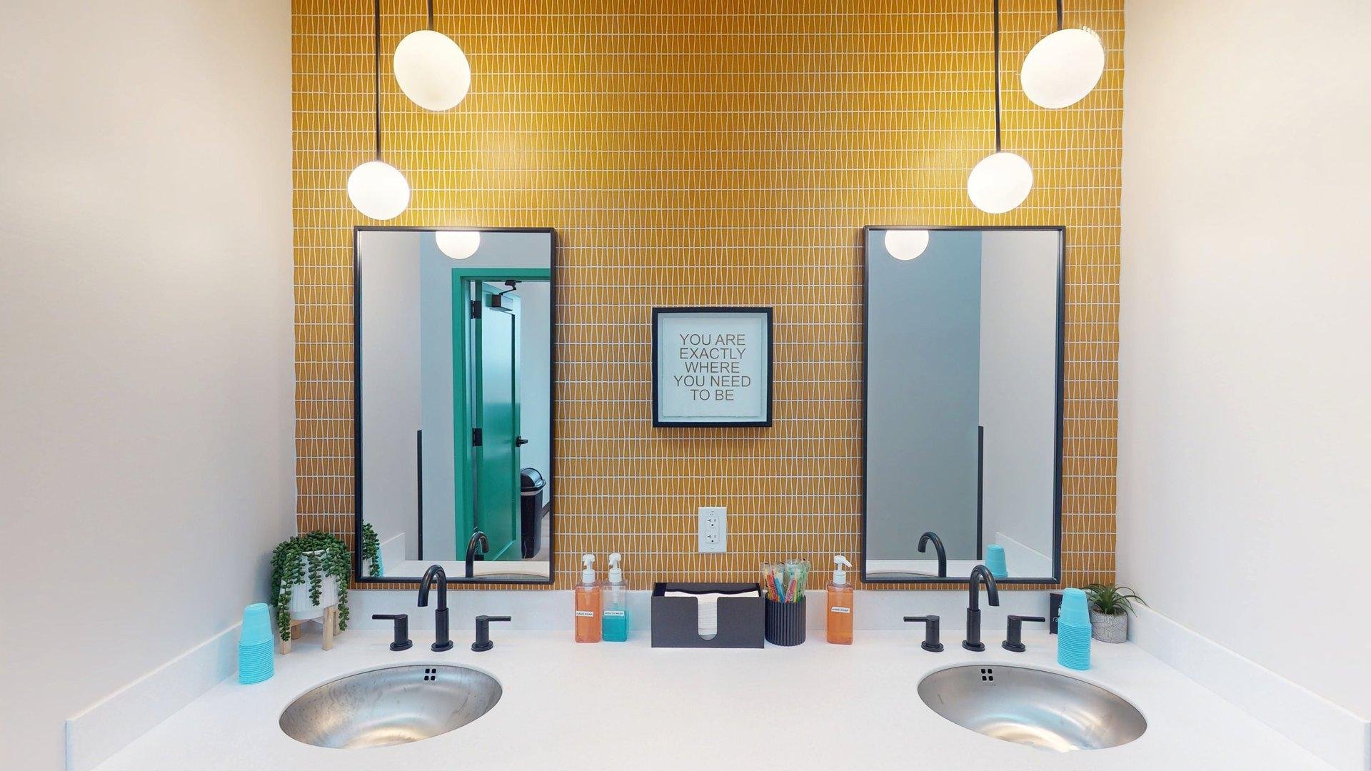Clean and modern orthodontic sink and mirror area at Shine Ortho Studio designed for patient comfort and hygiene.