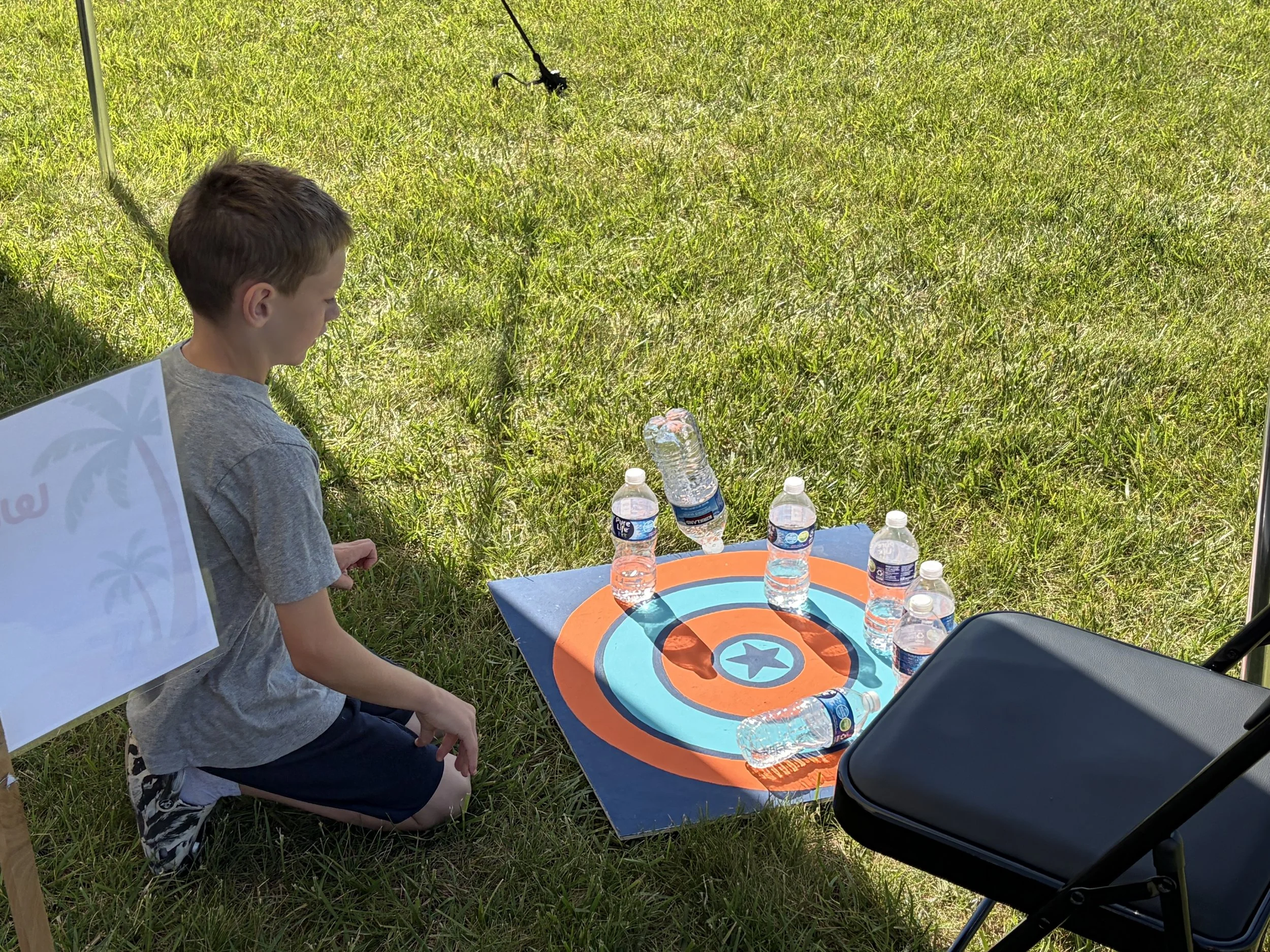 Child playing a fun outdoor game during Shine Ortho Studio's free Family Fun Day community event.