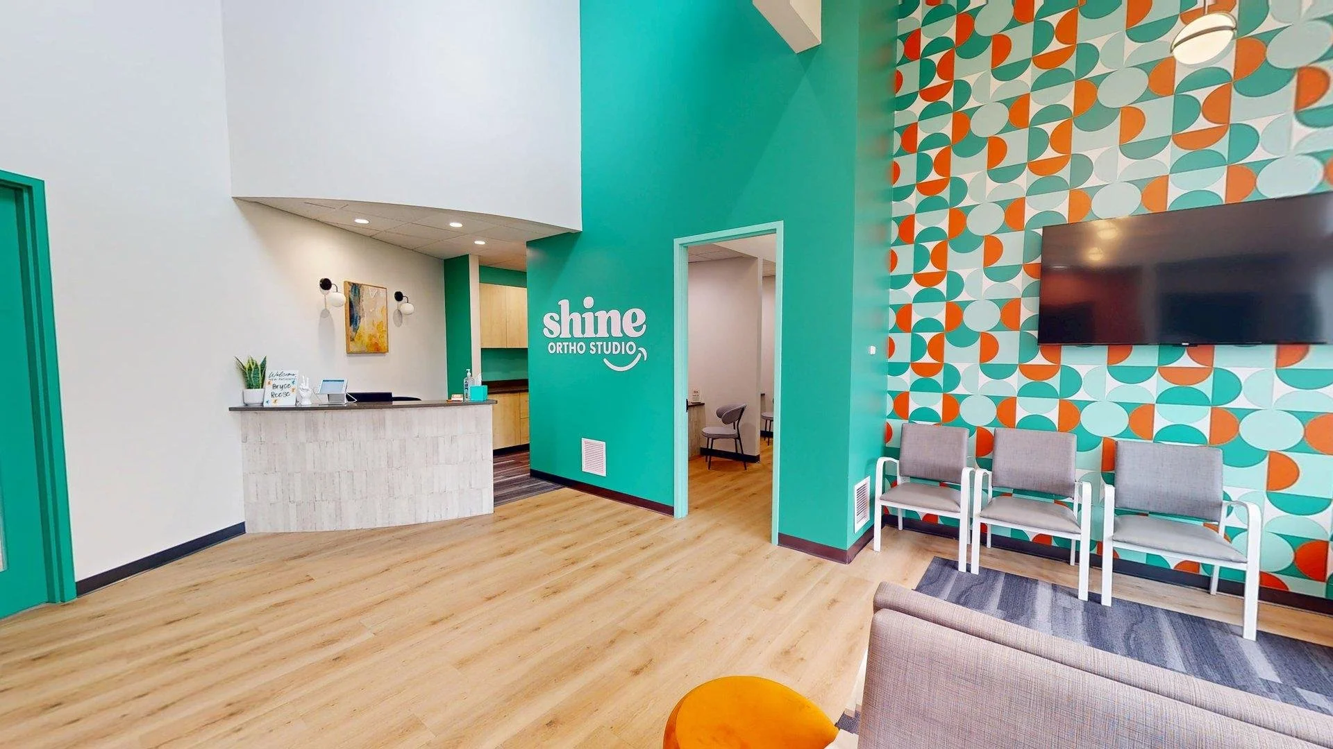 Modern waiting room interior at Shine Ortho Studio featuring a bright, welcoming space with seating, front desk, and contemporary design.