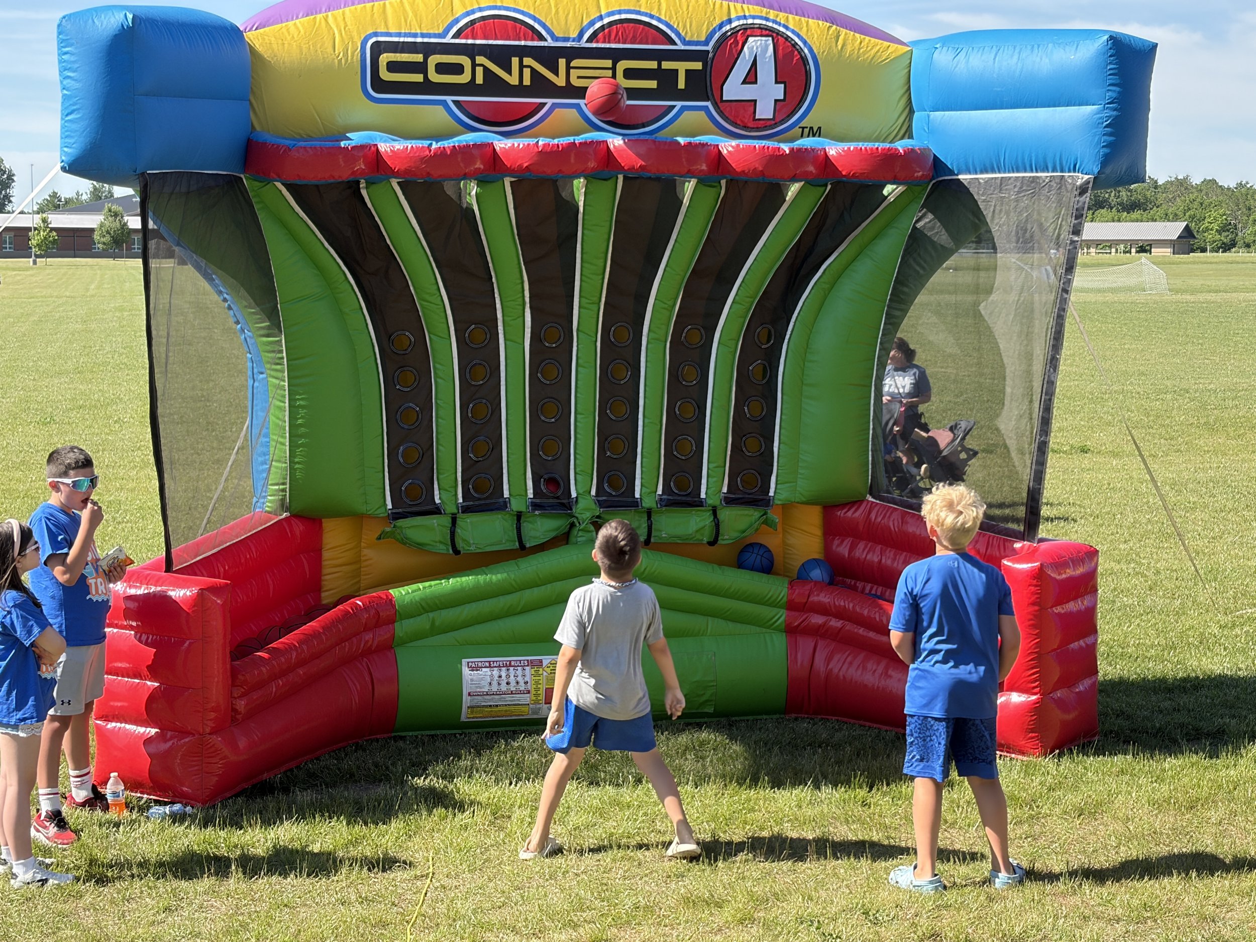Children playing giant Connect 4 during Shine Ortho Studio's free Family Fun Day community event.