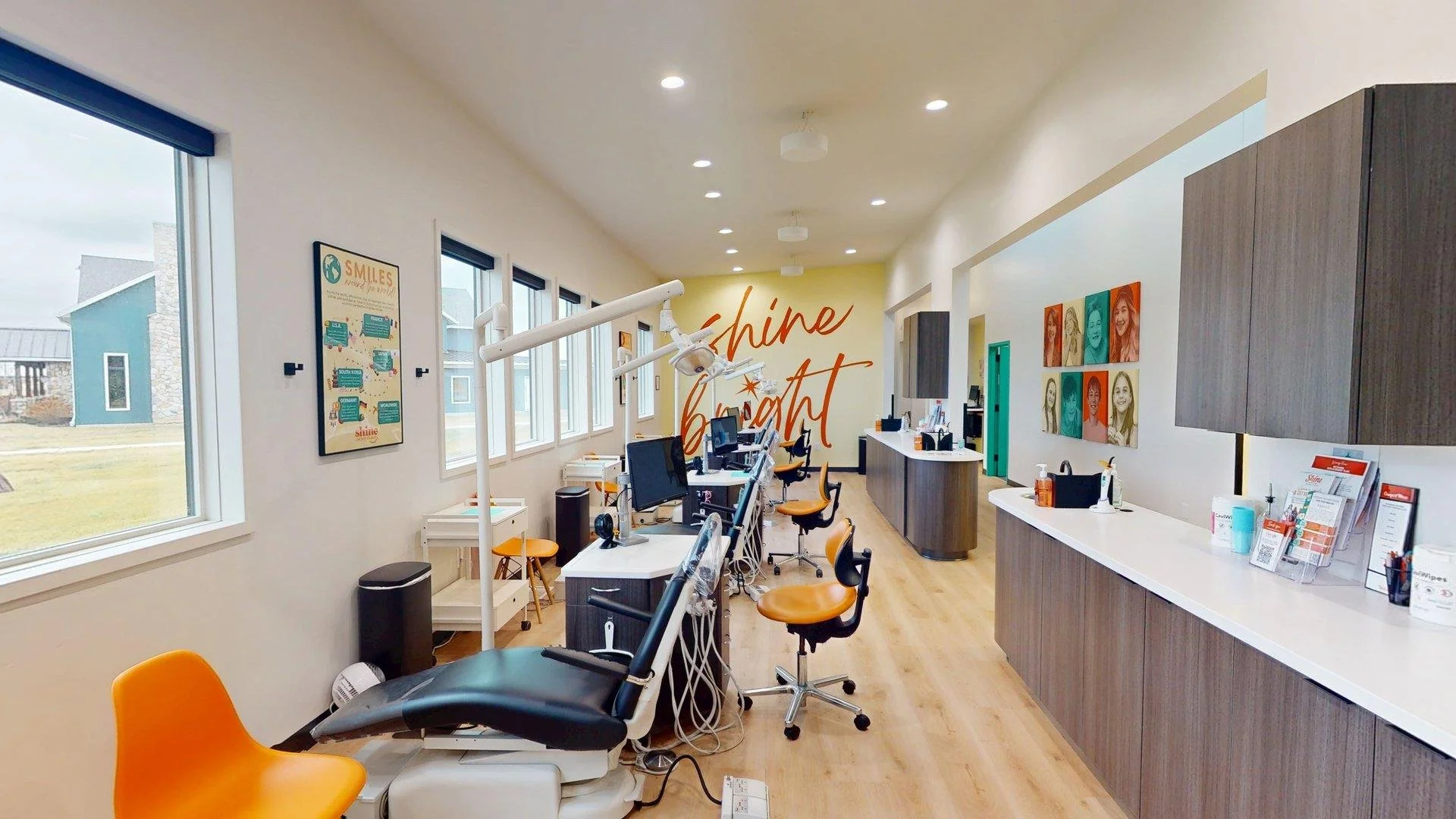 Open orthodontic treatment room at Shine Ortho Studio with multiple chairs, bright natural light, and modern design.