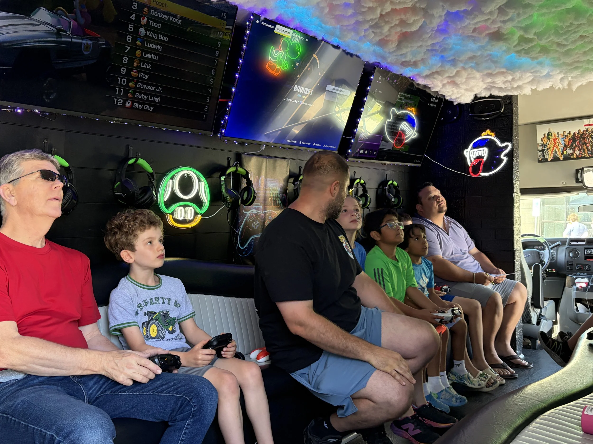 Families enjoying the gaming truck at Shine Ortho Studio's free Family Fun Day community event.