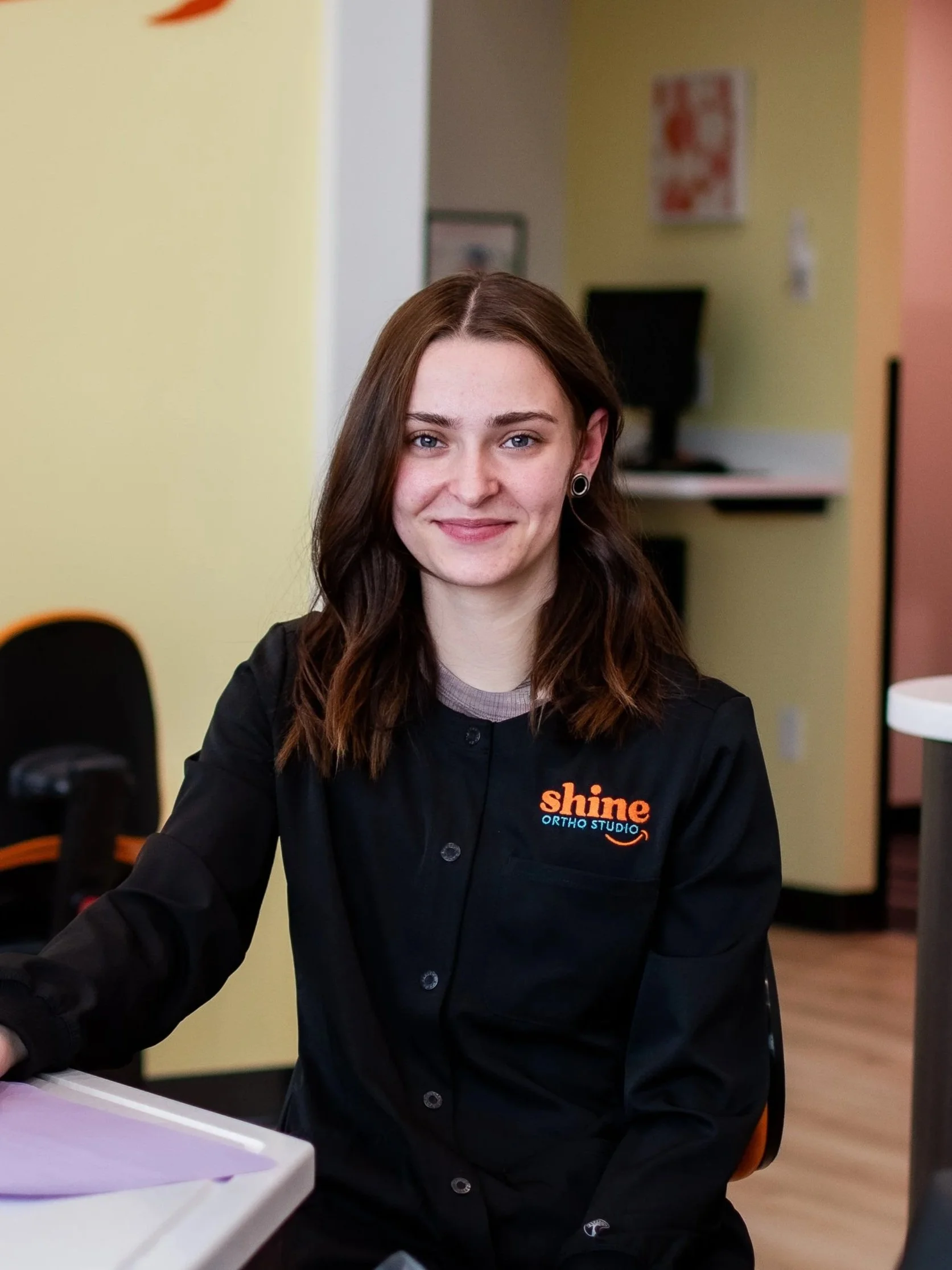 Alexis Stricklin, orthodontic dental assistant at Shine Ortho Studio, smiling in the office