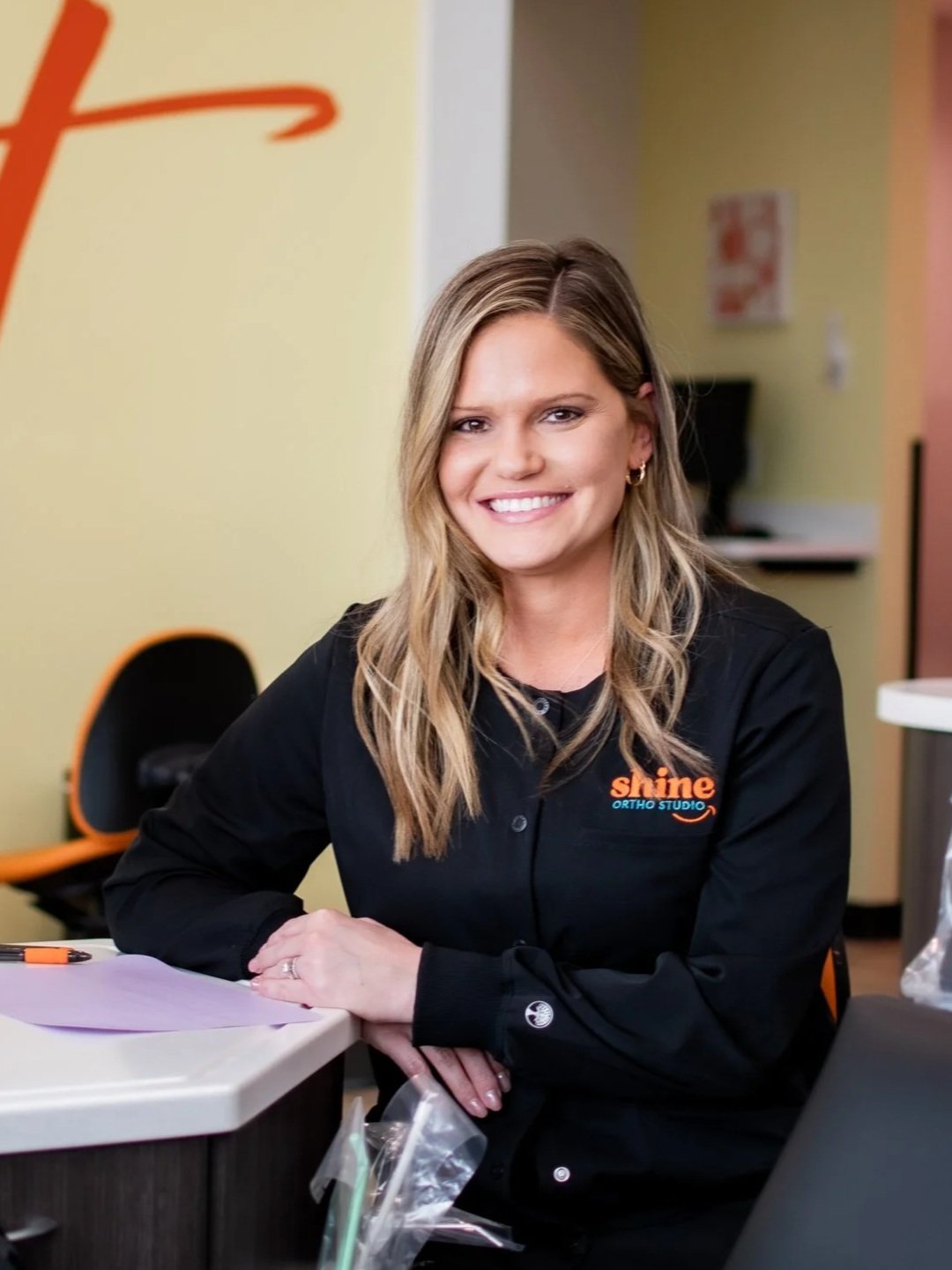 Andrea Murrey, orthodontic EFDA at Shine Ortho Studio, smiling in the clinical area