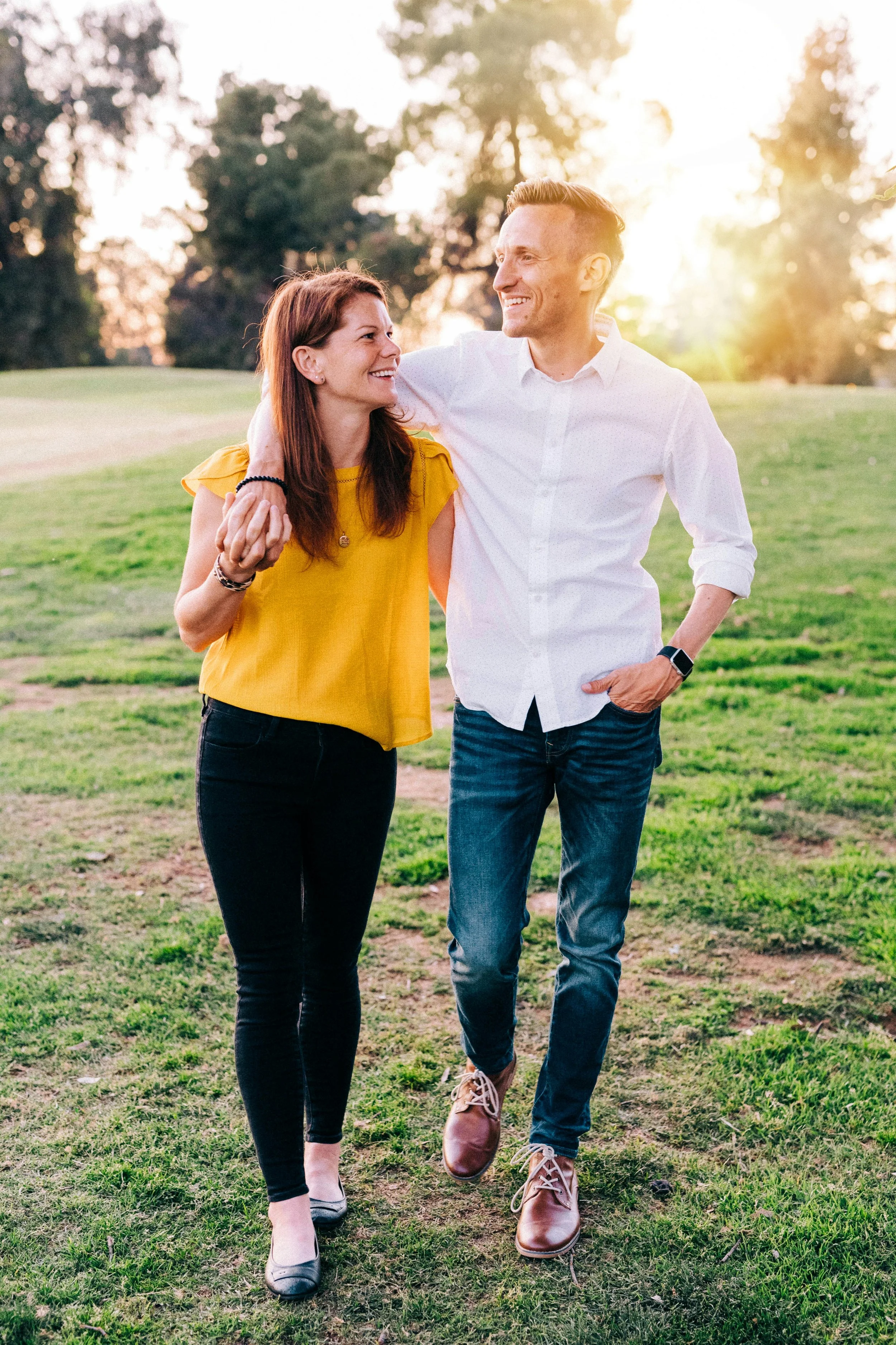 Couple walks in a park holding hands in Chilliwack BC