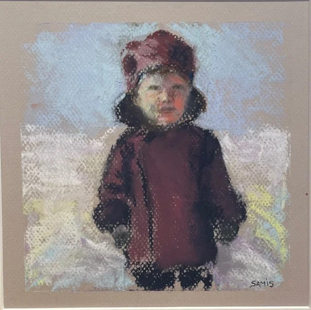 Child in a maroon jacket and hat standing outdoors on a cloudy day.