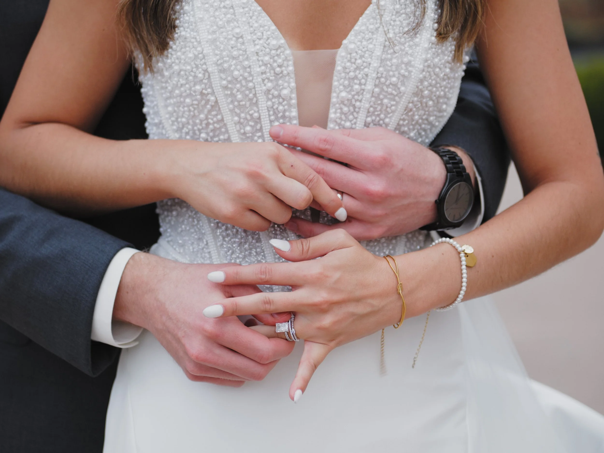 close up of bride and groom placing rings on each other's hands at Bella Sera Event Venue in Pittsburgh by famous auteur Bywater Lens.