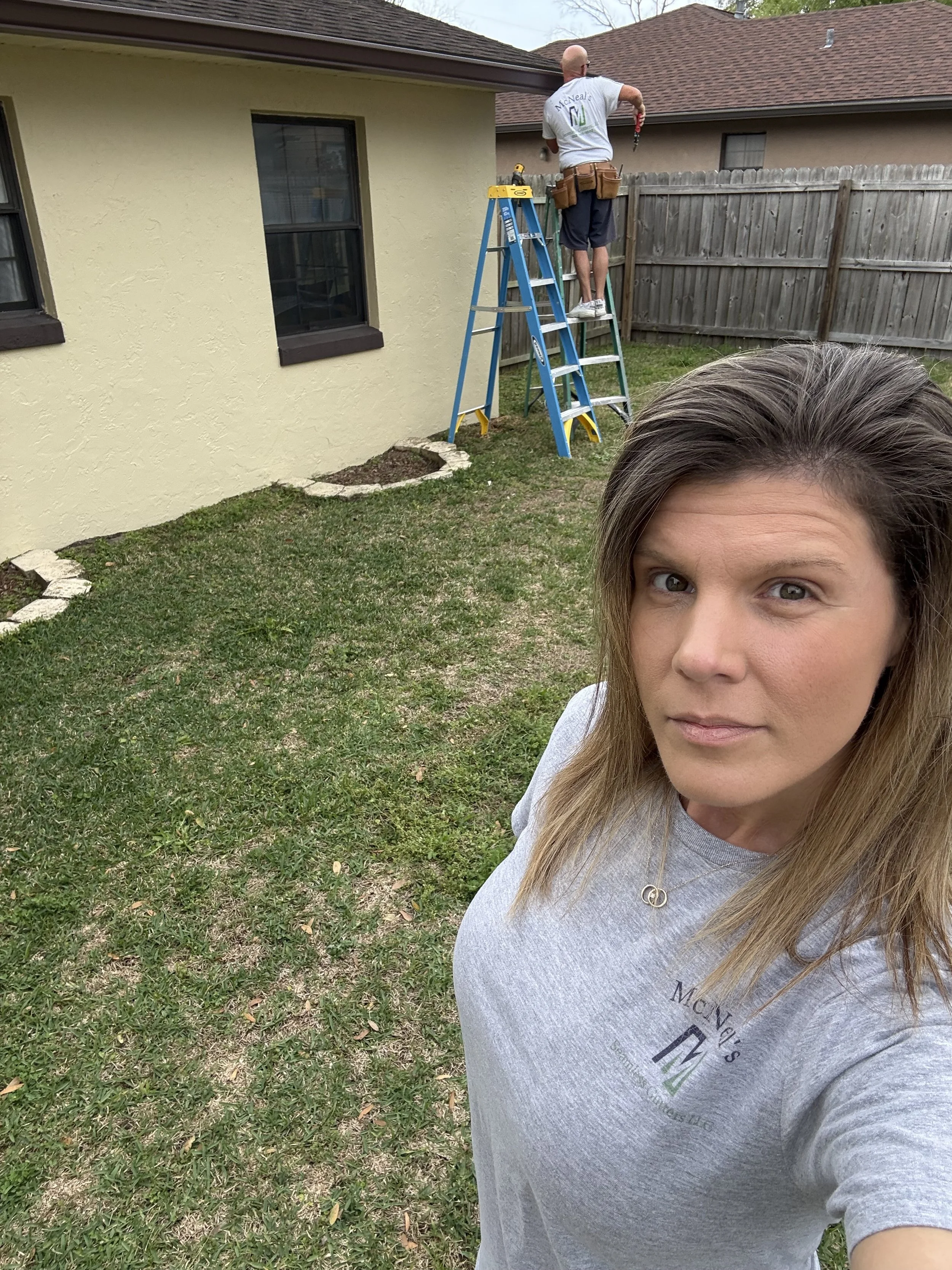 Danielle McNeal on-site during a McNeal’s Seamless Gutters installation.