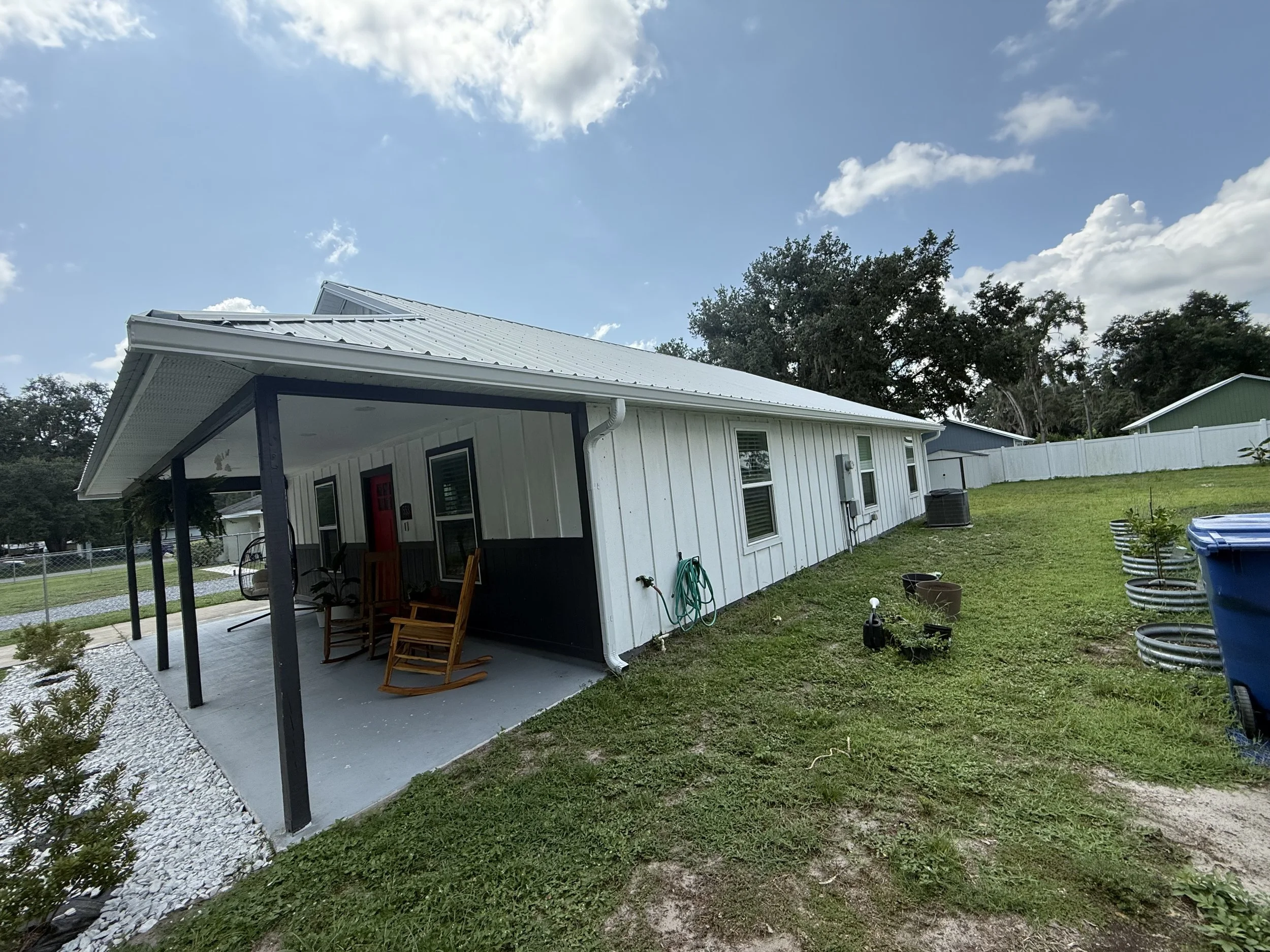 White seamless gutters and downspouts installed on home in Webster, Florida