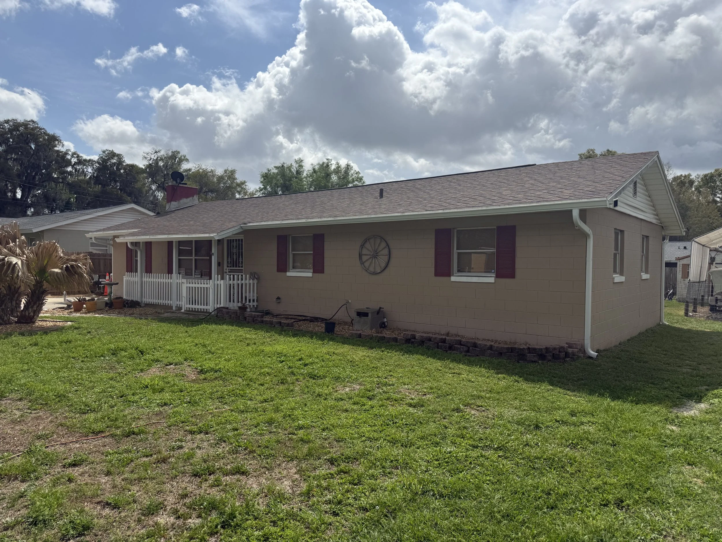 White seamless gutters and downspouts installed on rear of home in Summerfield, Florida