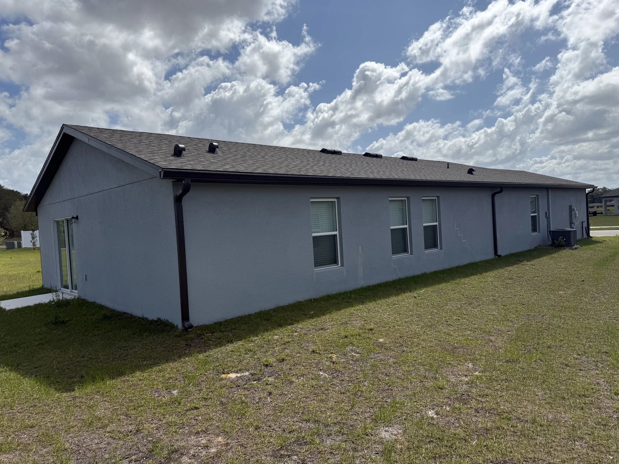 Dark Bronze seamless gutters and downspouts installed on home in Brooksville, Florida
