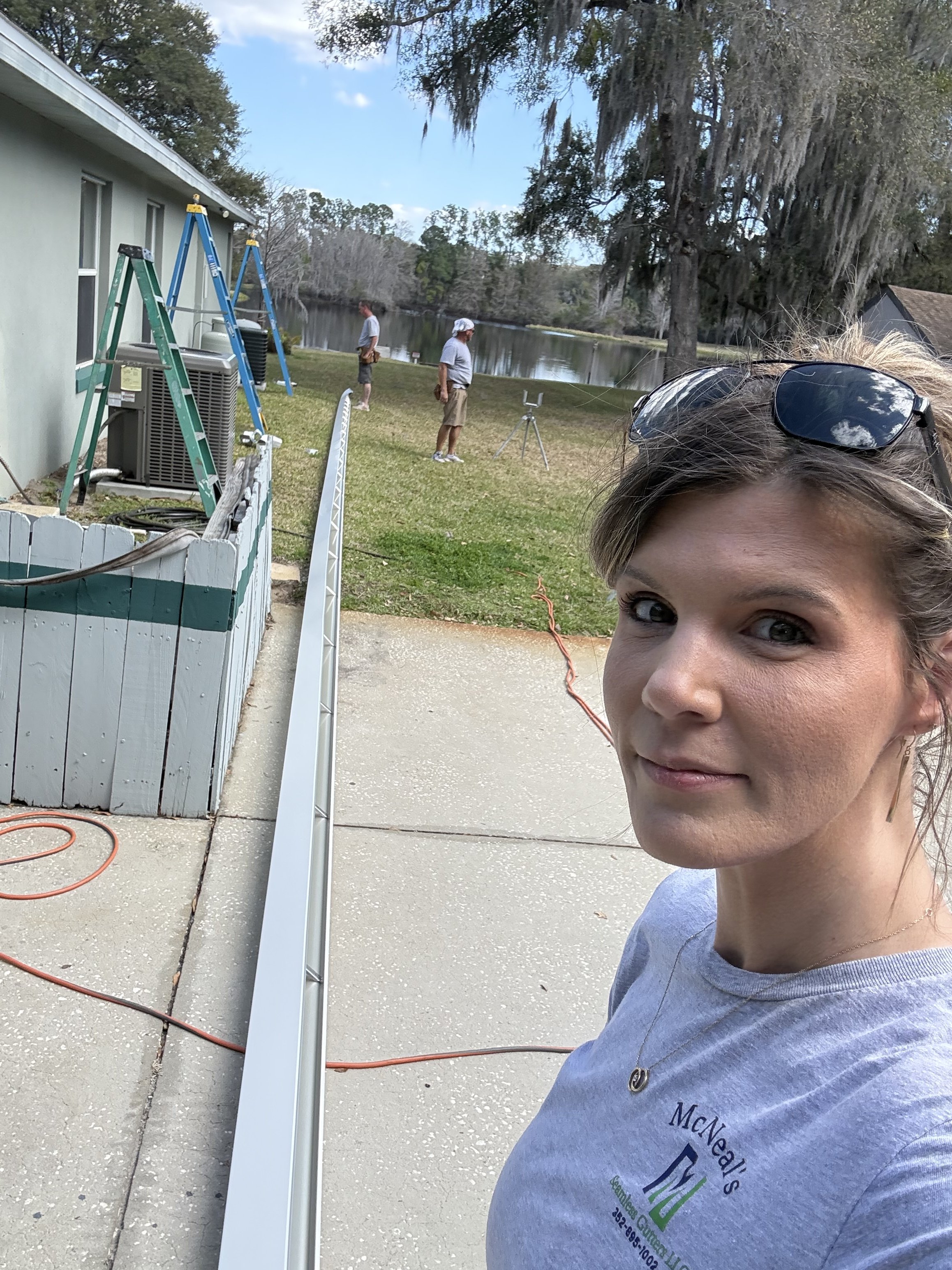 Danielle McNeal assisting on-site during a residential gutter project.