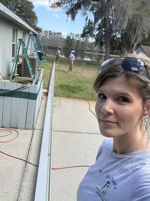 Danielle McNeal assisting on-site during a residential gutter project.