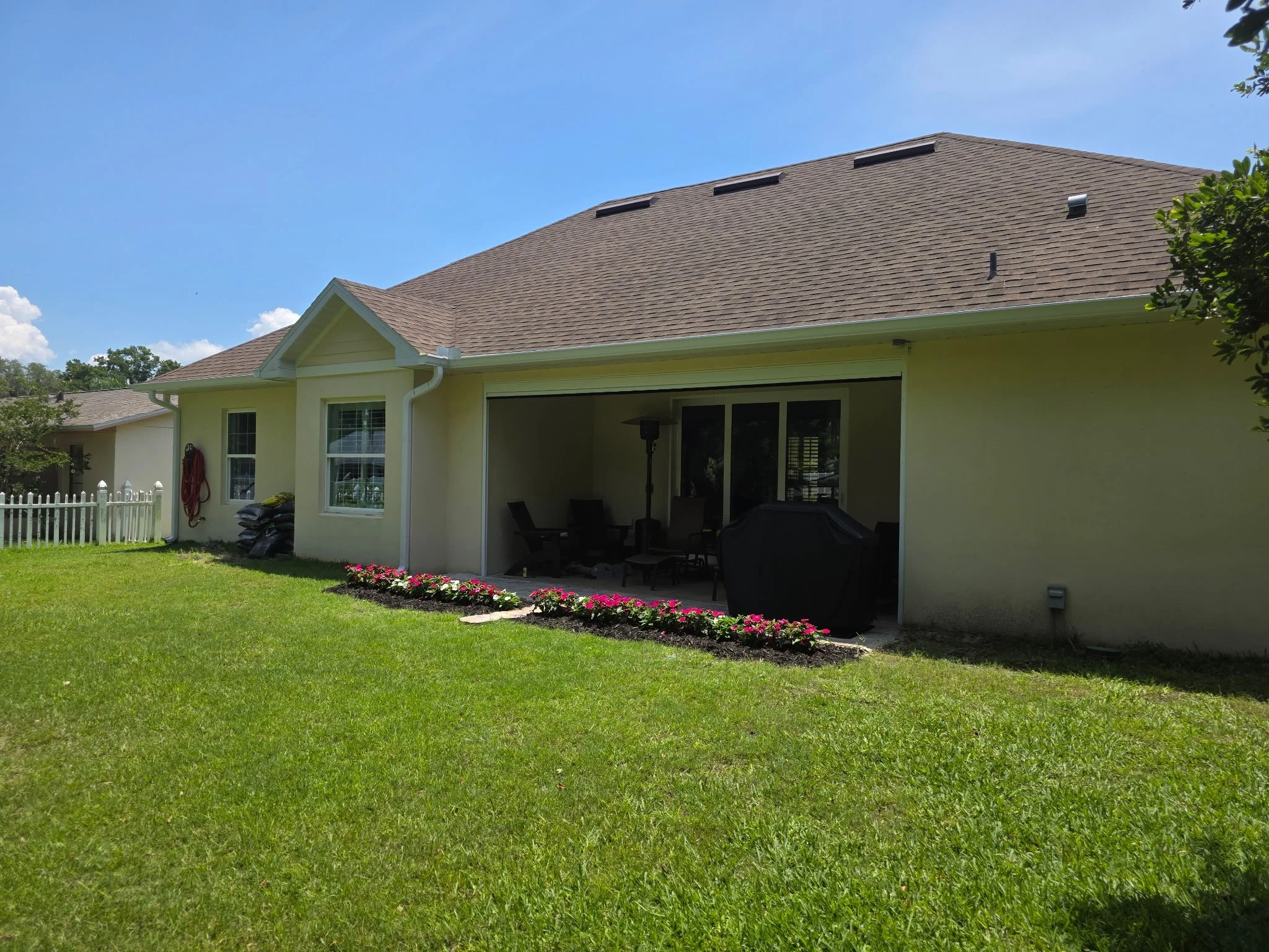 White seamless gutters and downspouts installed on rear of home in Harbor Shores, Leesburg, Florida