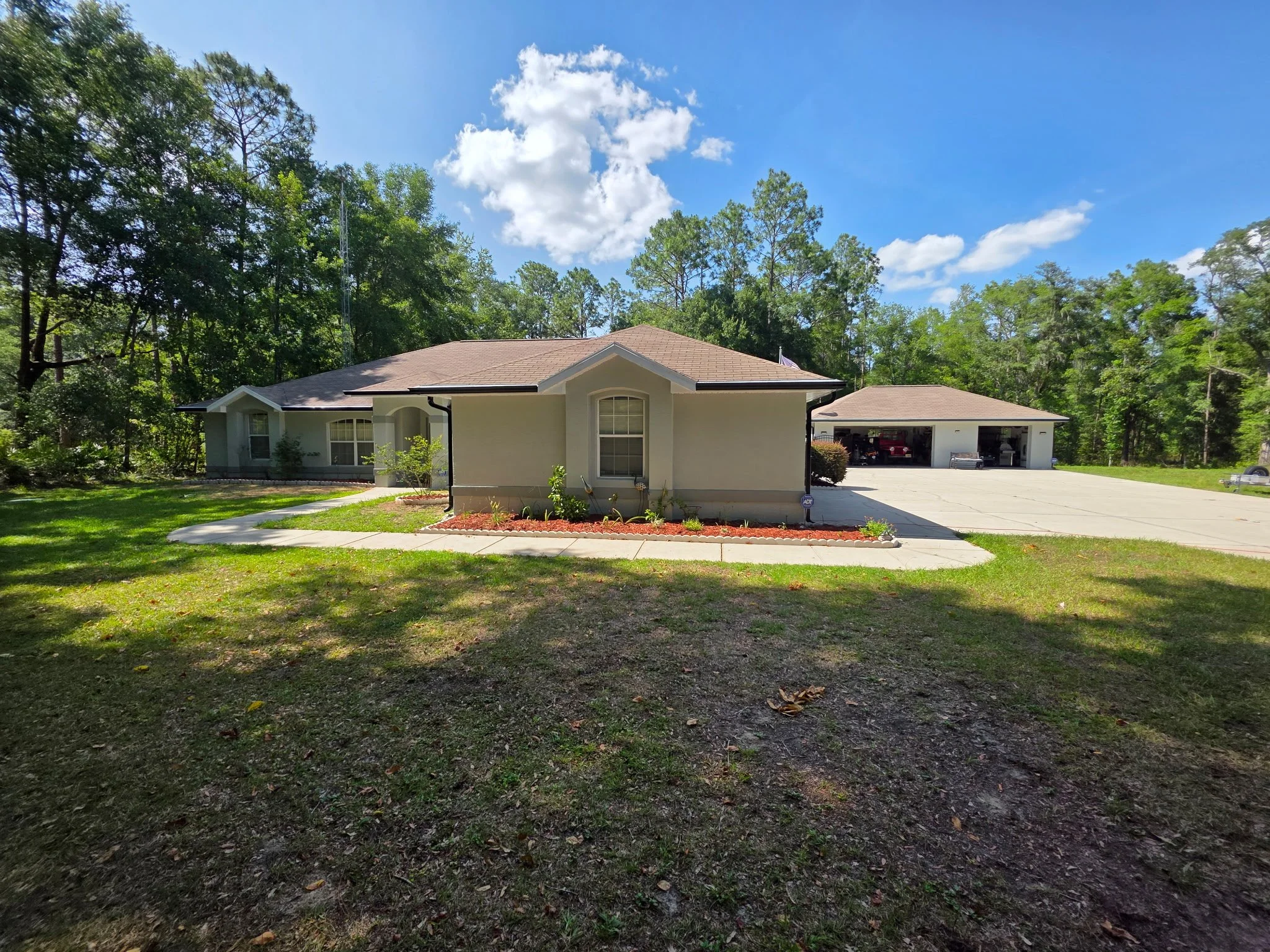 Dark Bronze seamless gutters installed on detached garage in Rolling Hills, Dunnellon, Florida
