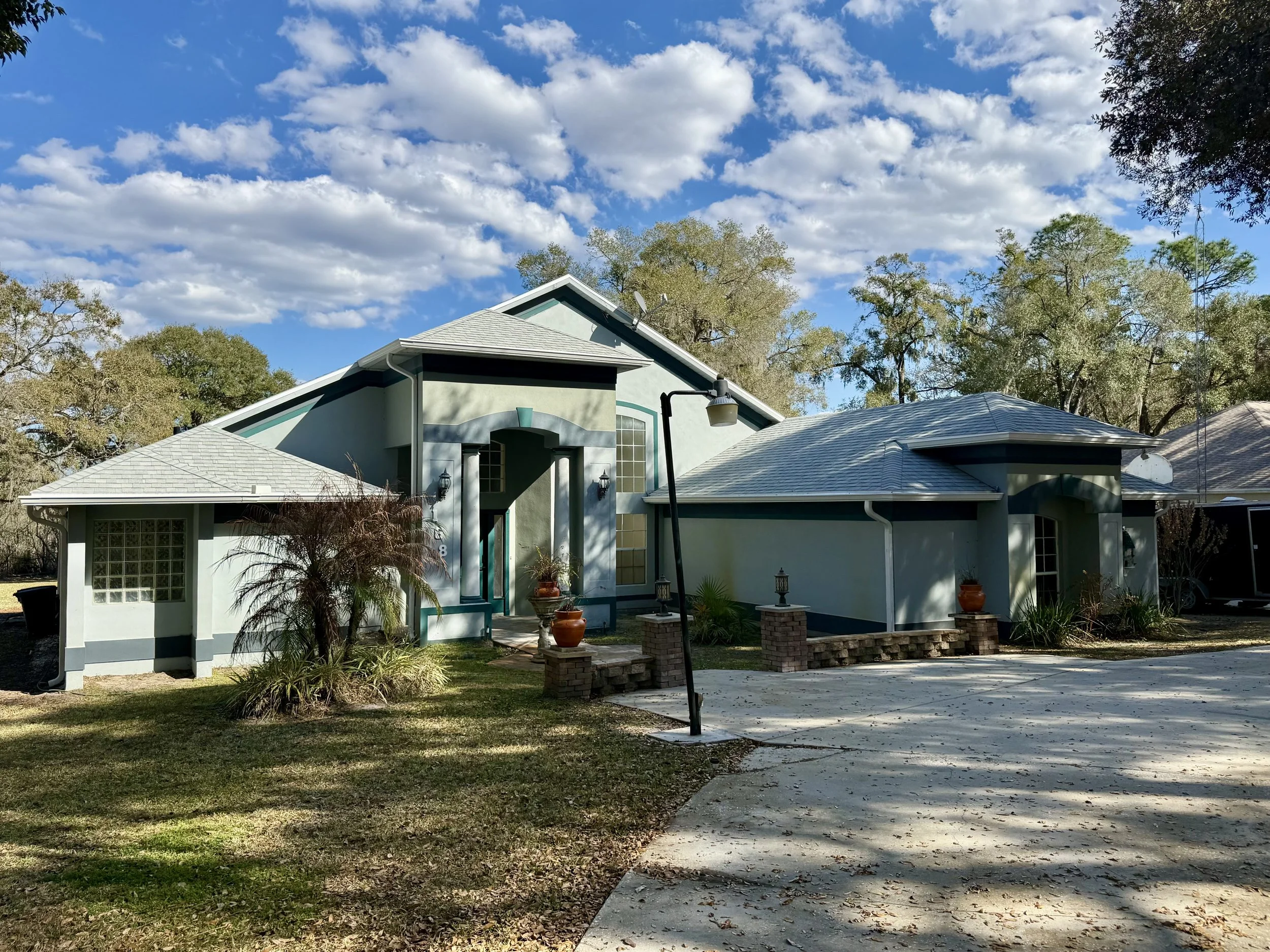 Front view of white seamless gutter installation on home in Sunset Pond, Mount Dora, Florida