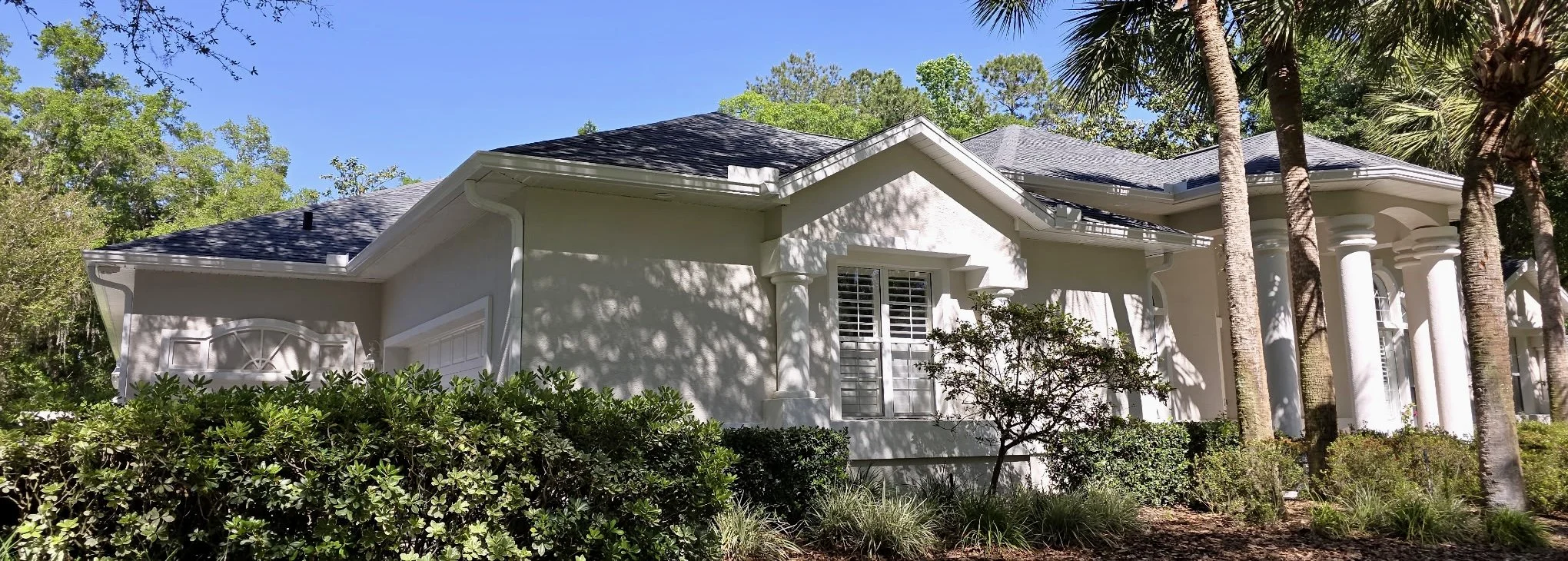 Front view of white seamless gutter installation on home in Country Club of Ocala, Florida