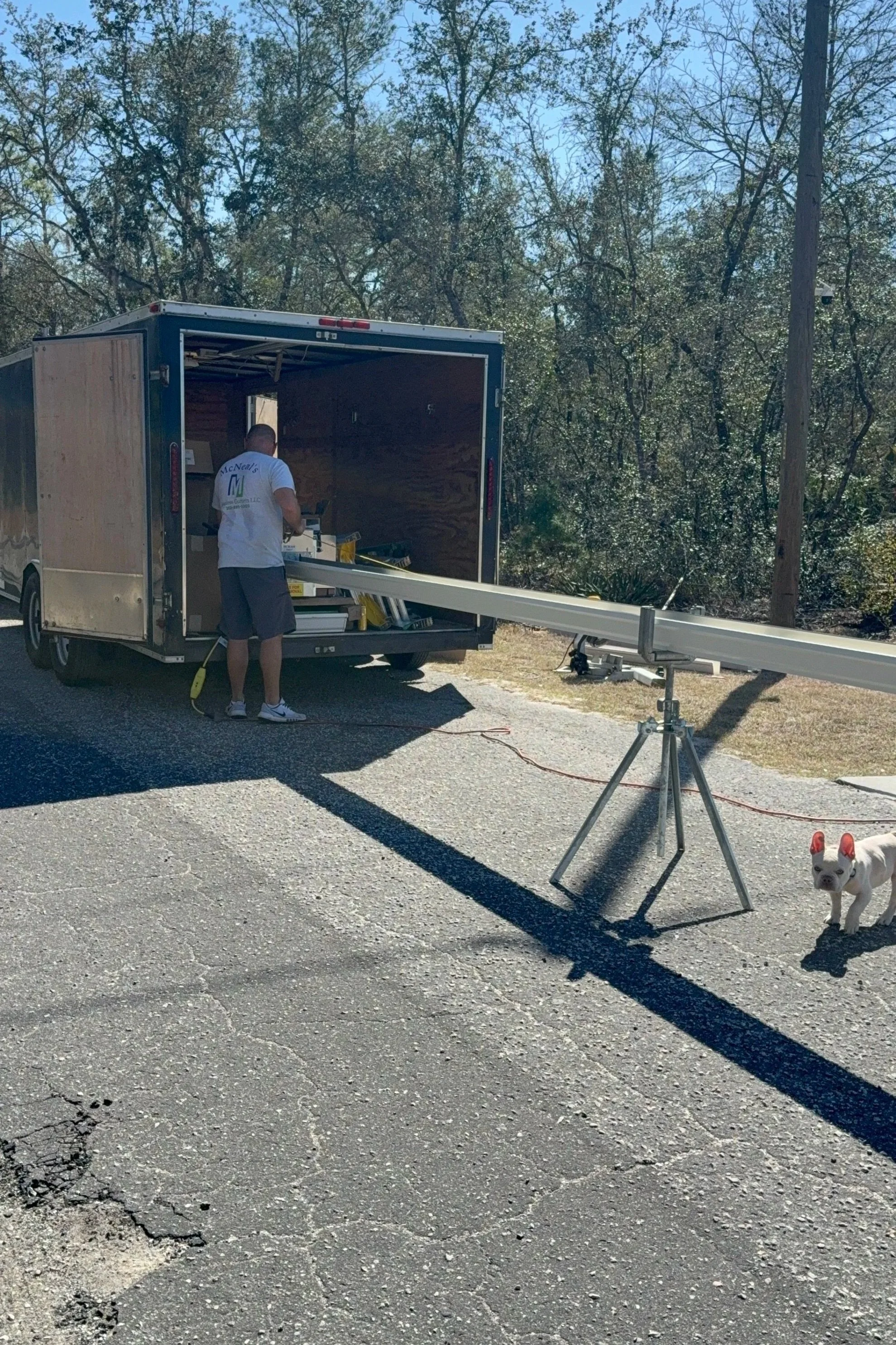 Danny forming seamless gutter on-site from the gutter machine in Ocklawaha, Florida