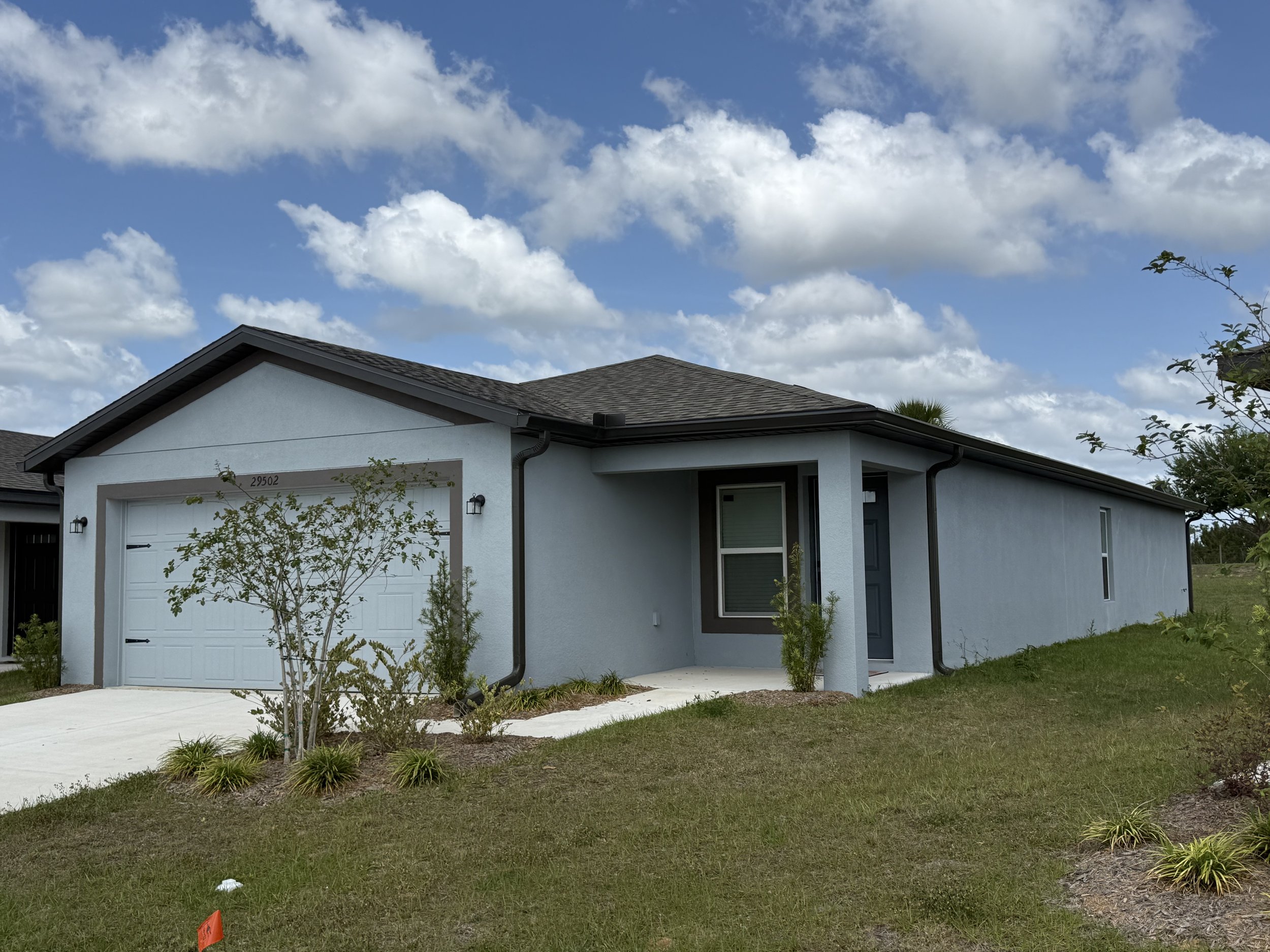 Dark Bronze seamless gutters and downspouts installed on home in Brooksville, Florida