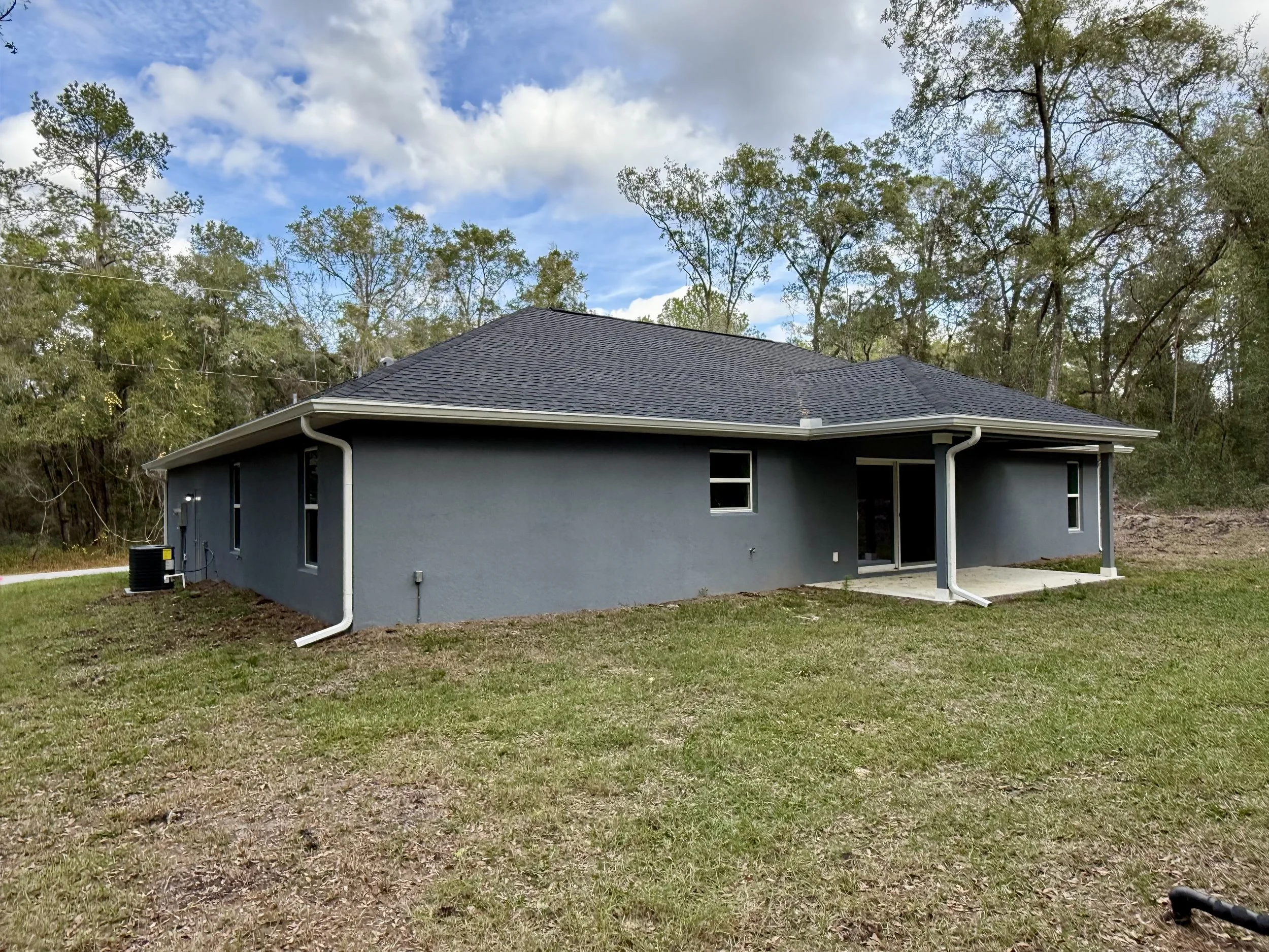 White seamless gutters and downspouts installed on rear of home in Citrus Springs, Florida