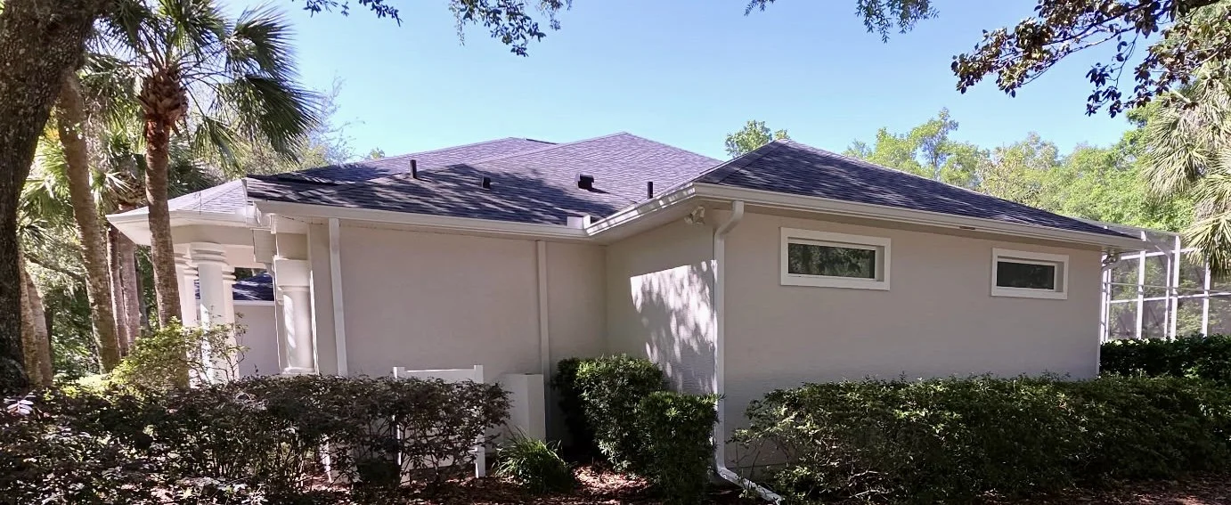 Side view of white seamless gutters and downspouts installed in Country Club of Ocala, Florida