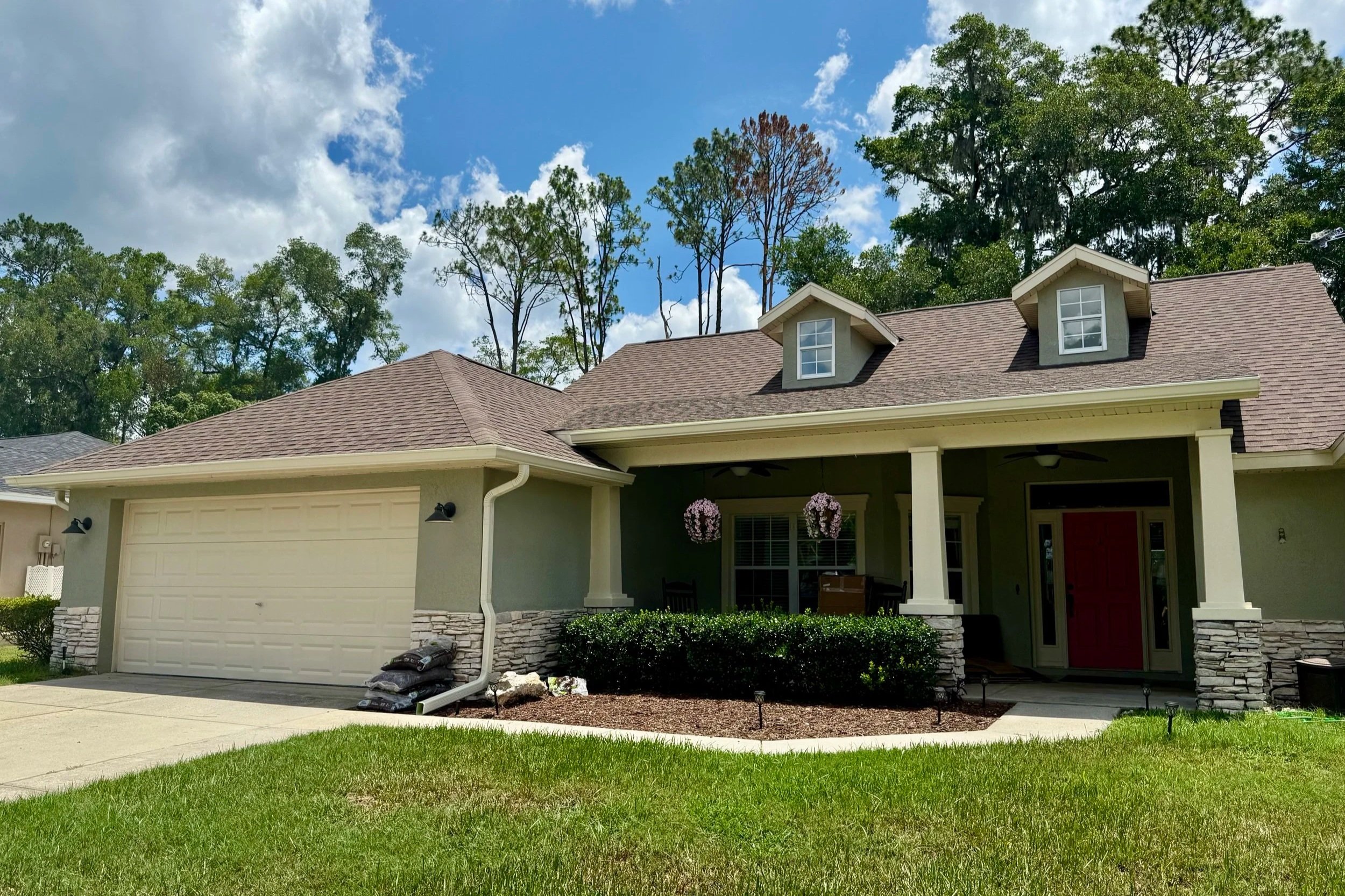 Cream seamless gutters installed on a home in Indian Pines V in Ocala, Florida.