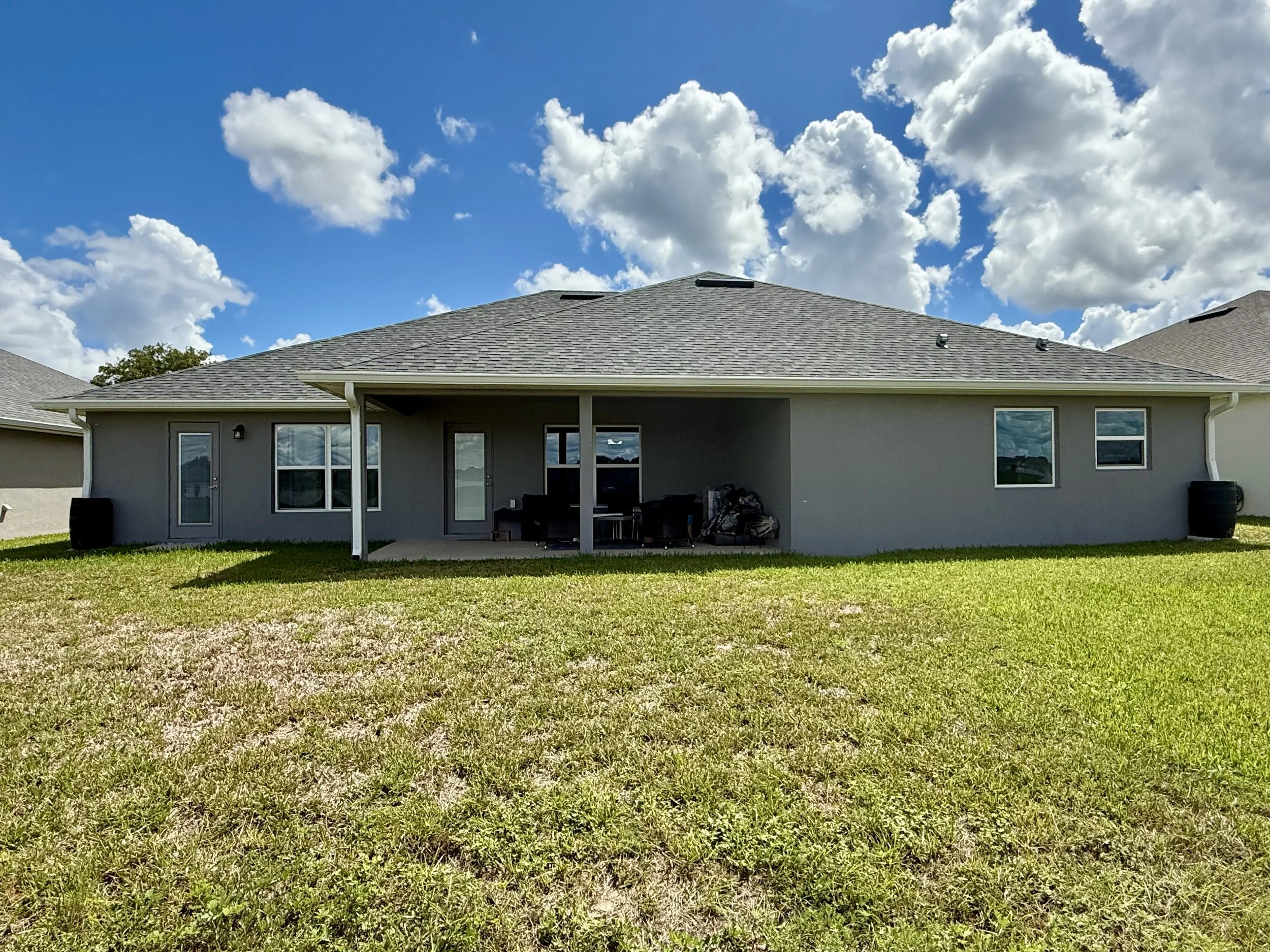 Rear view of white seamless gutters and downspouts on home in Citrus Springs, Florida