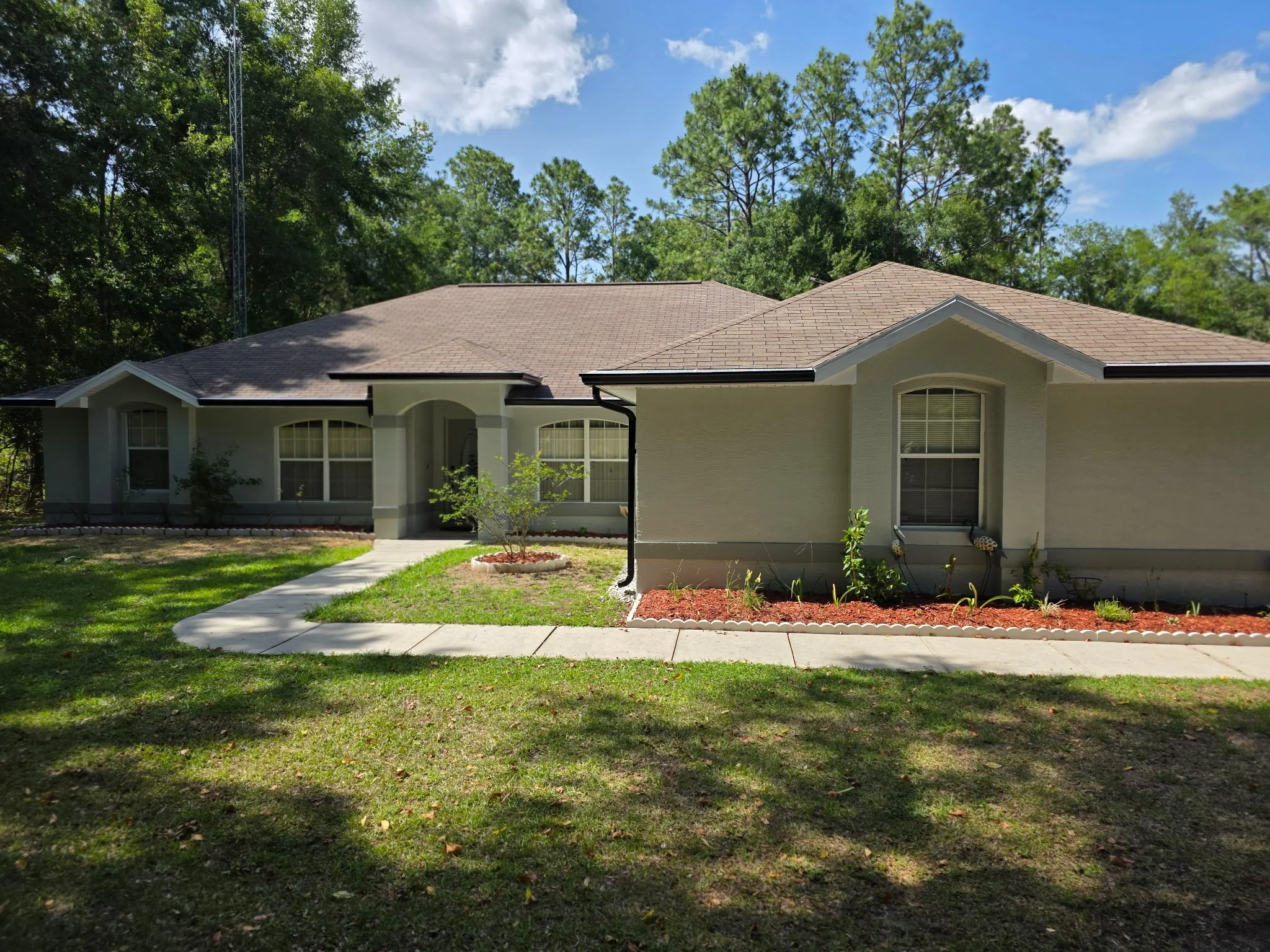Dark Bronze seamless gutters and downspouts installed on home in Rolling Hills, Dunnellon, Florida