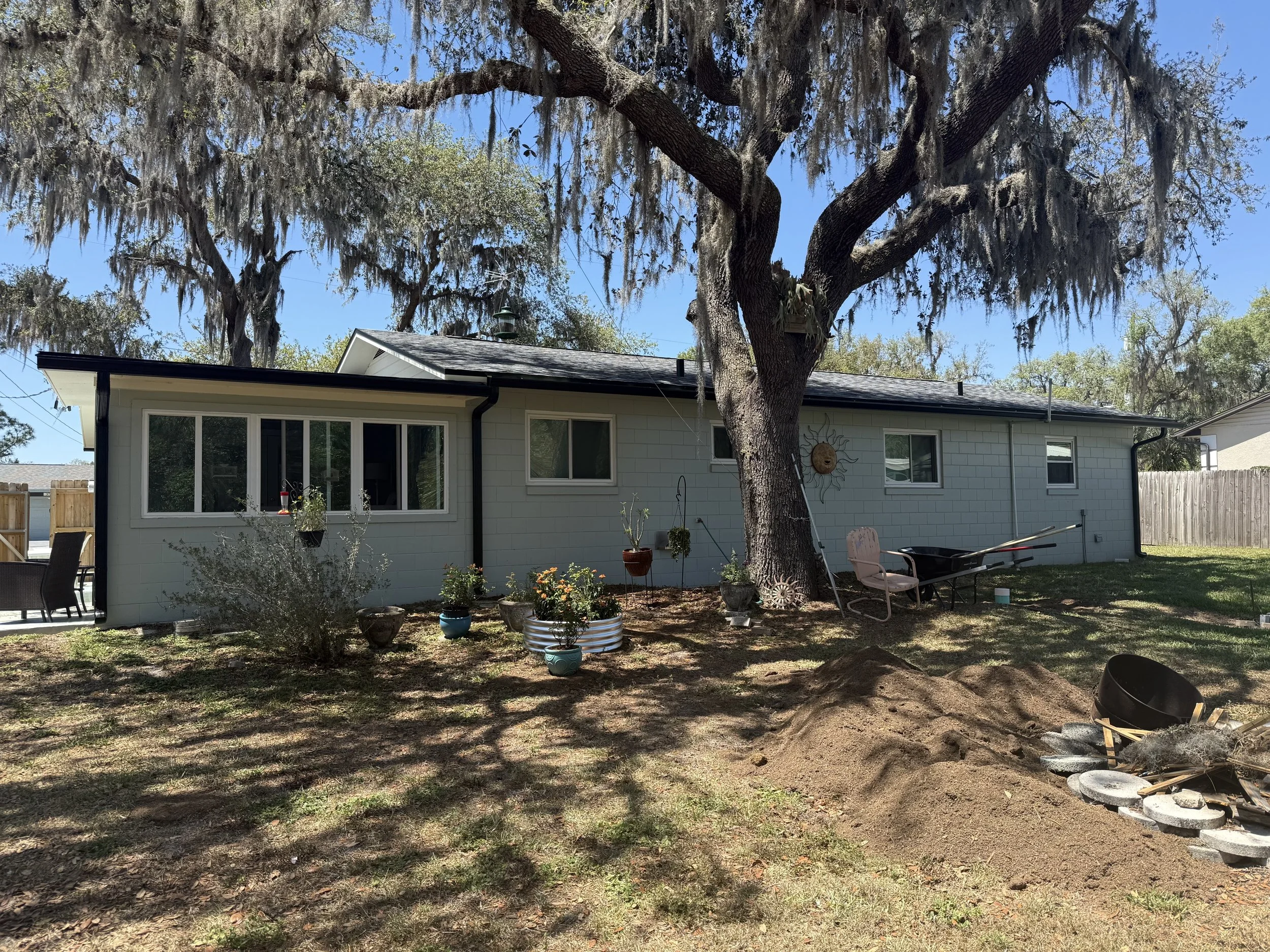 Black seamless gutters and downspouts installed on rear of home in Umatilla, Florida