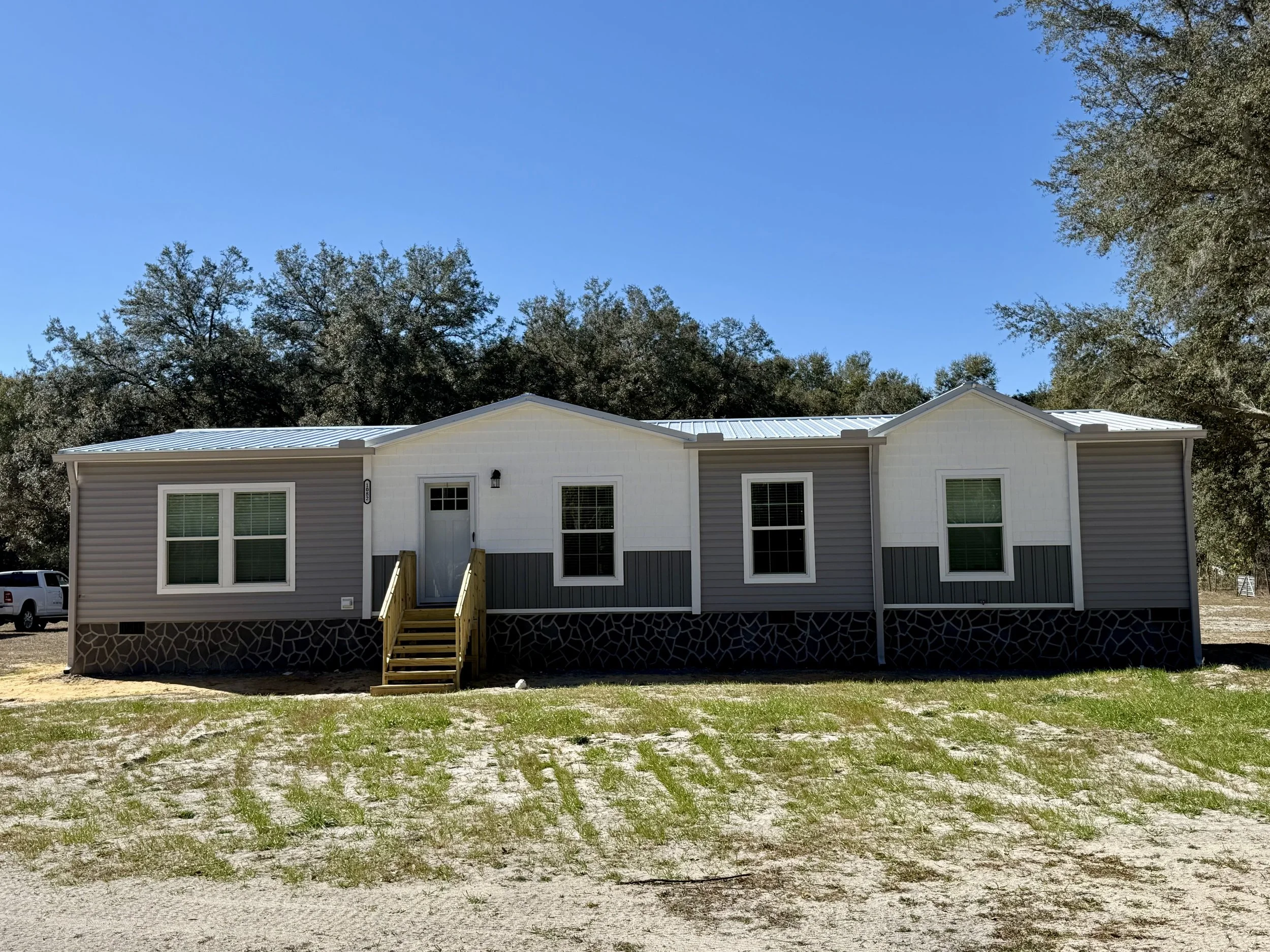 Seamless gutters and downspouts installed on mobile home in Oxford, Florida