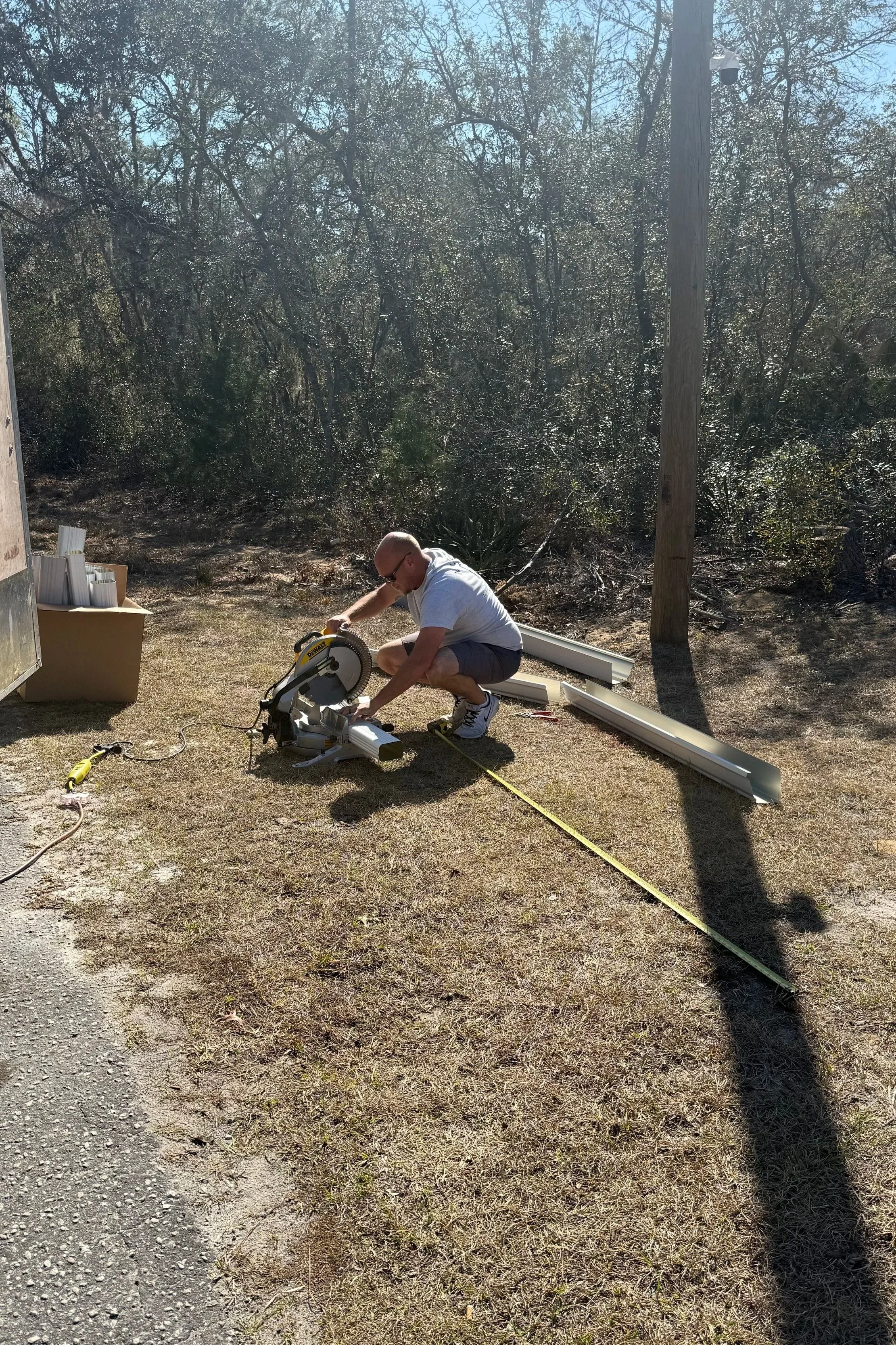 Danny cutting a downspout during a seamless gutter installation in Ocklawaha, Florida