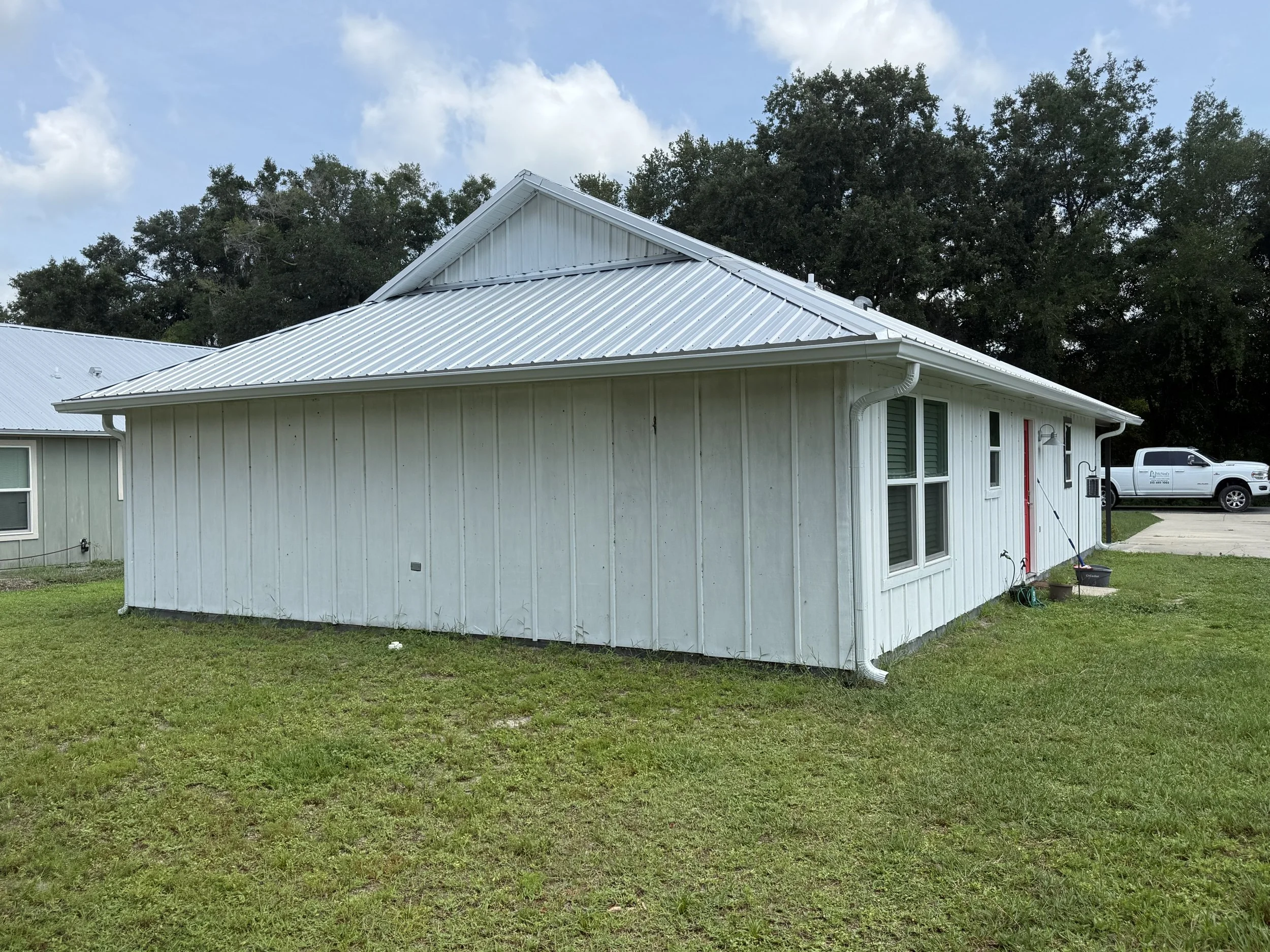 White seamless gutters and downspouts installed on home in Webster, Florida