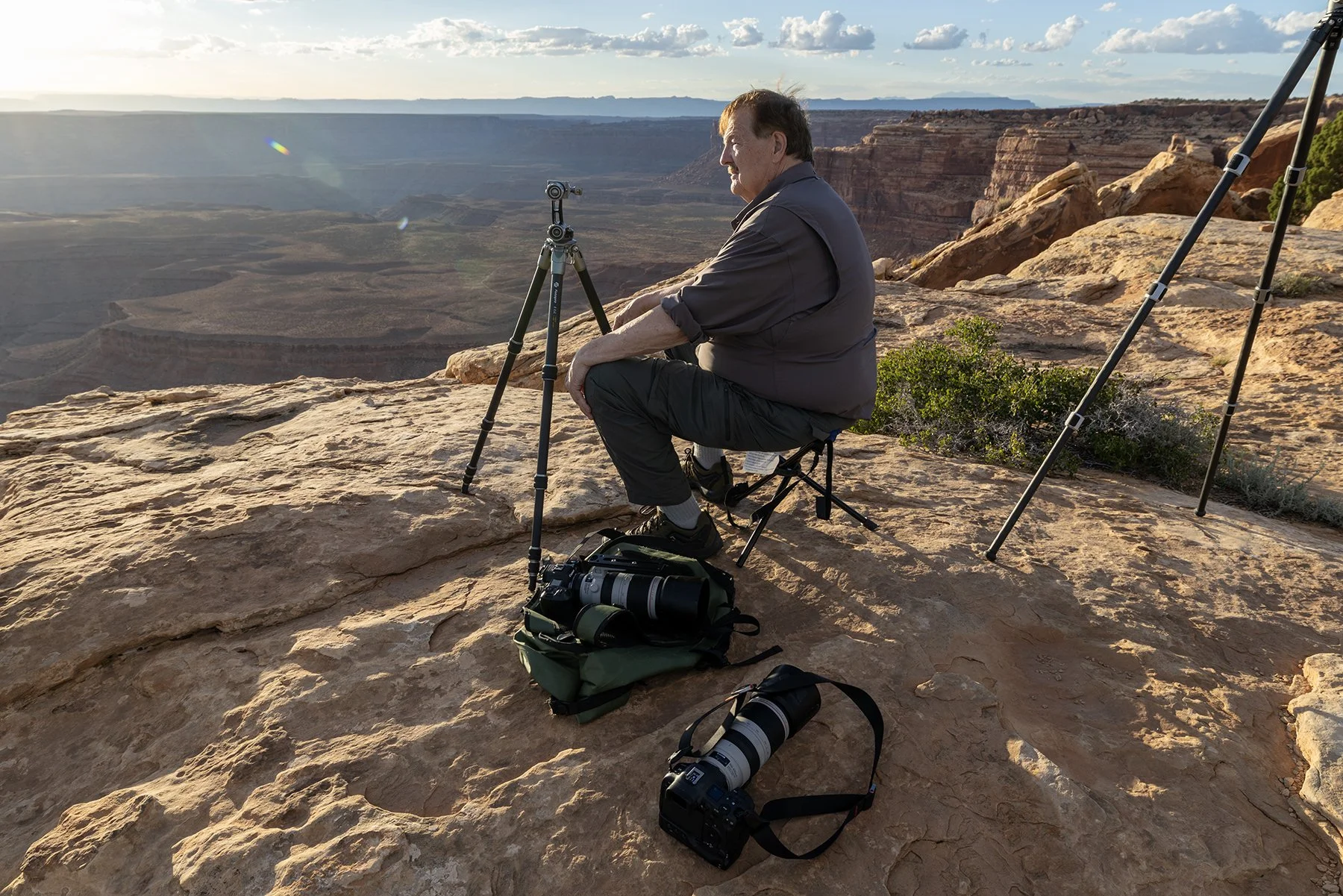 A photography workshop particpant waits for sunset at Muley Point
