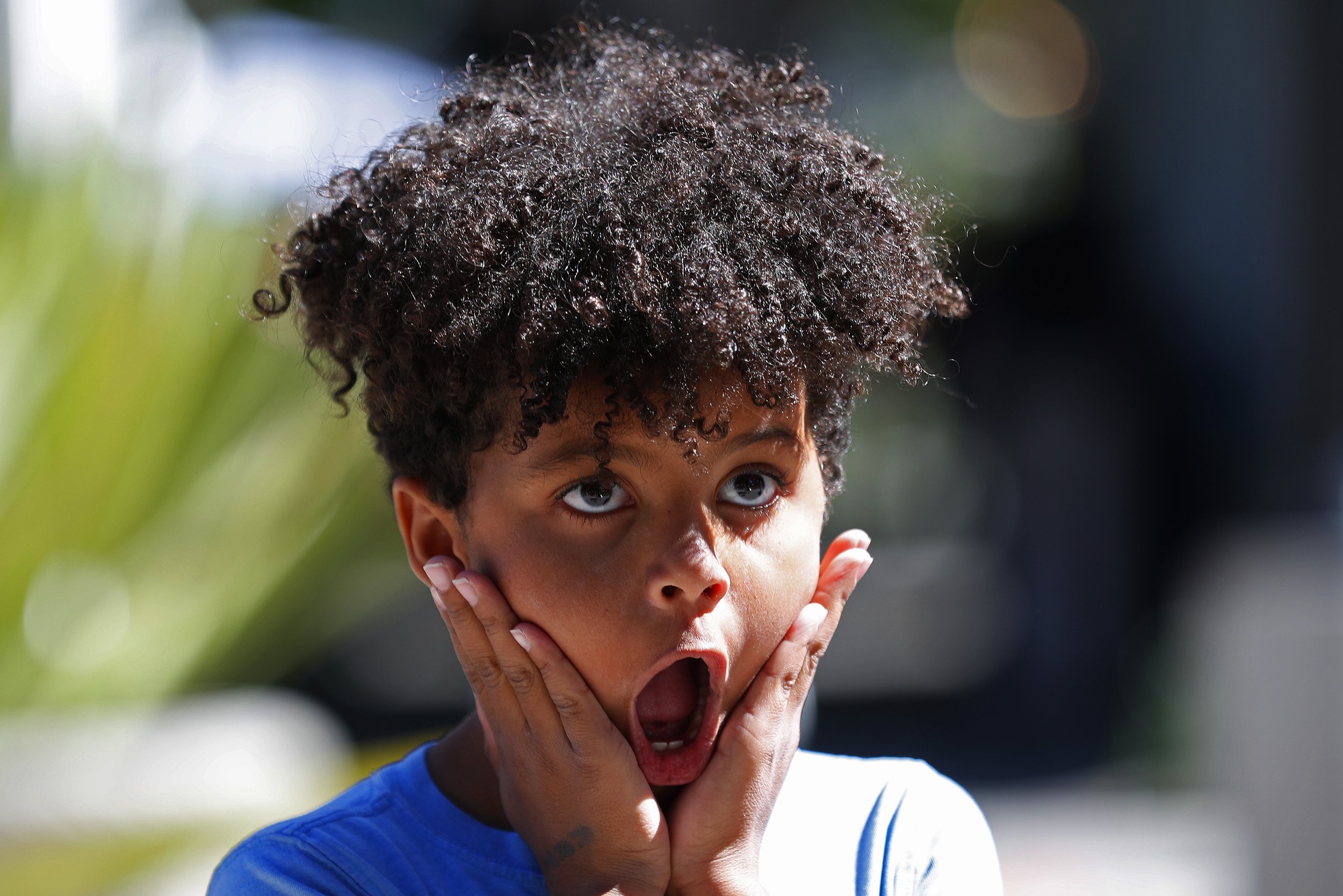 Child making surprised expression with hands on cheeks during my coverage of the Utah Arts Festival as part of my event coverage.