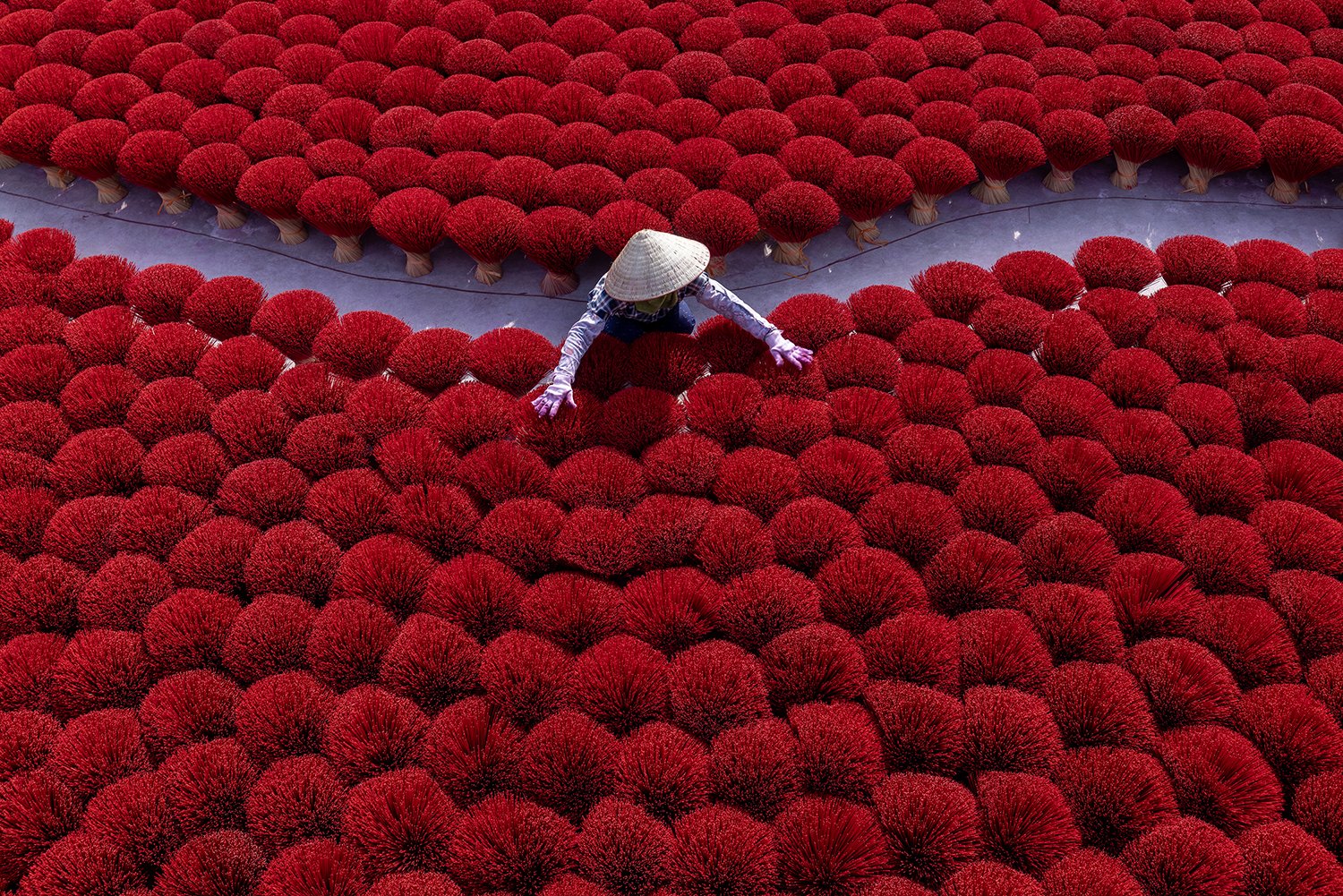 A worker organzies insense sticks at a factory in Vietnam as part of a photography workshop.