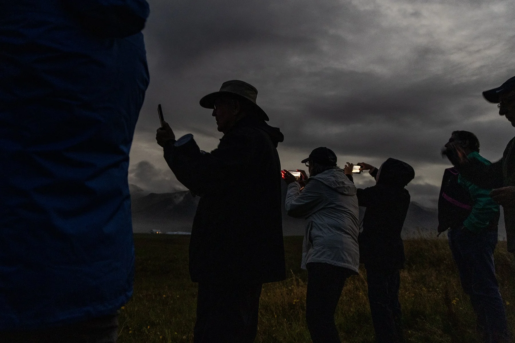 A darkened Icelandic sky, totality overhead, and a group simply taking it all in.
