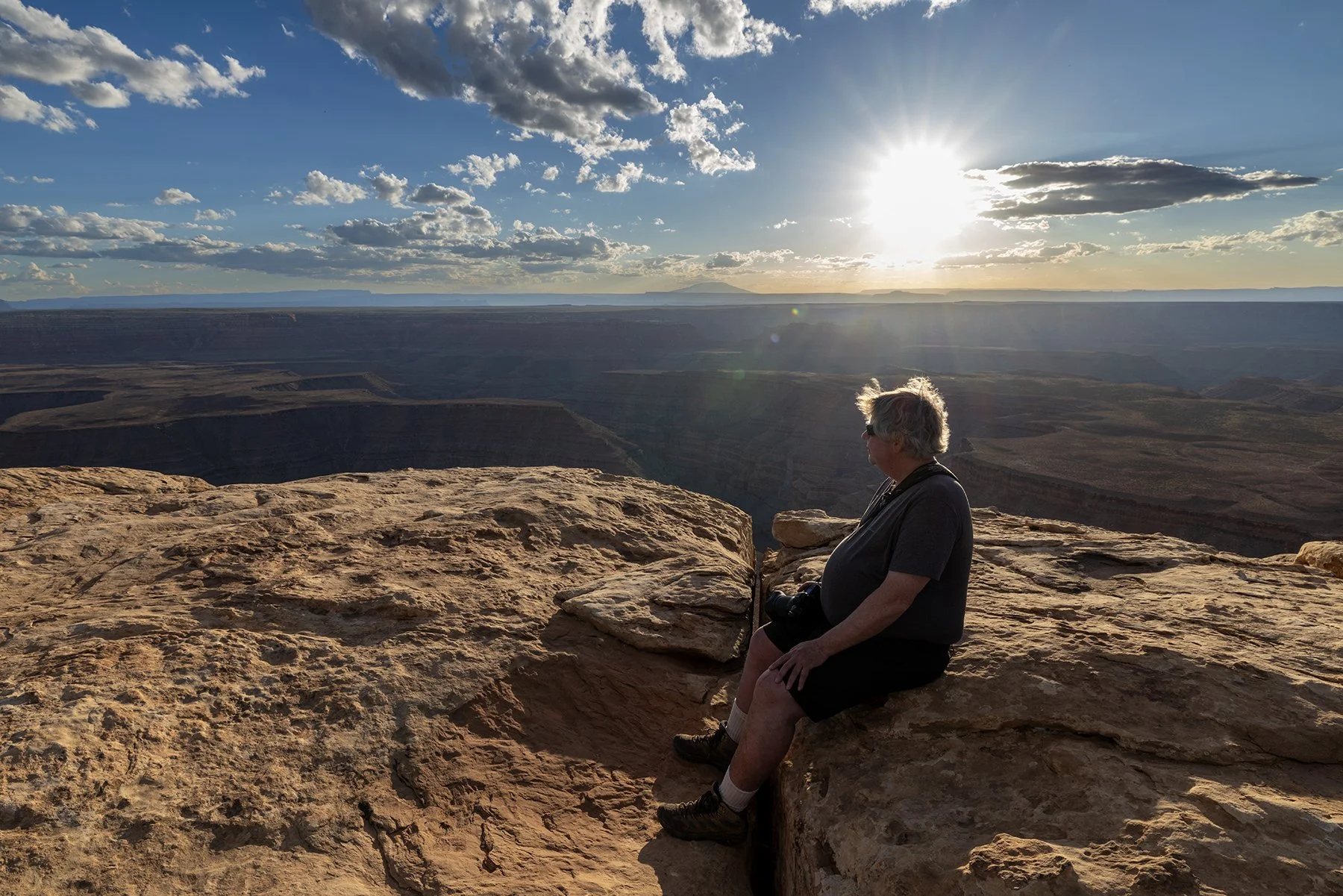A photography workshop particpant waits for sunset at Muley Point